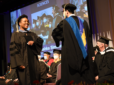 Saskia La-nushka Simone Darnley​​​​​​​, OTD '22 walks across the stage.