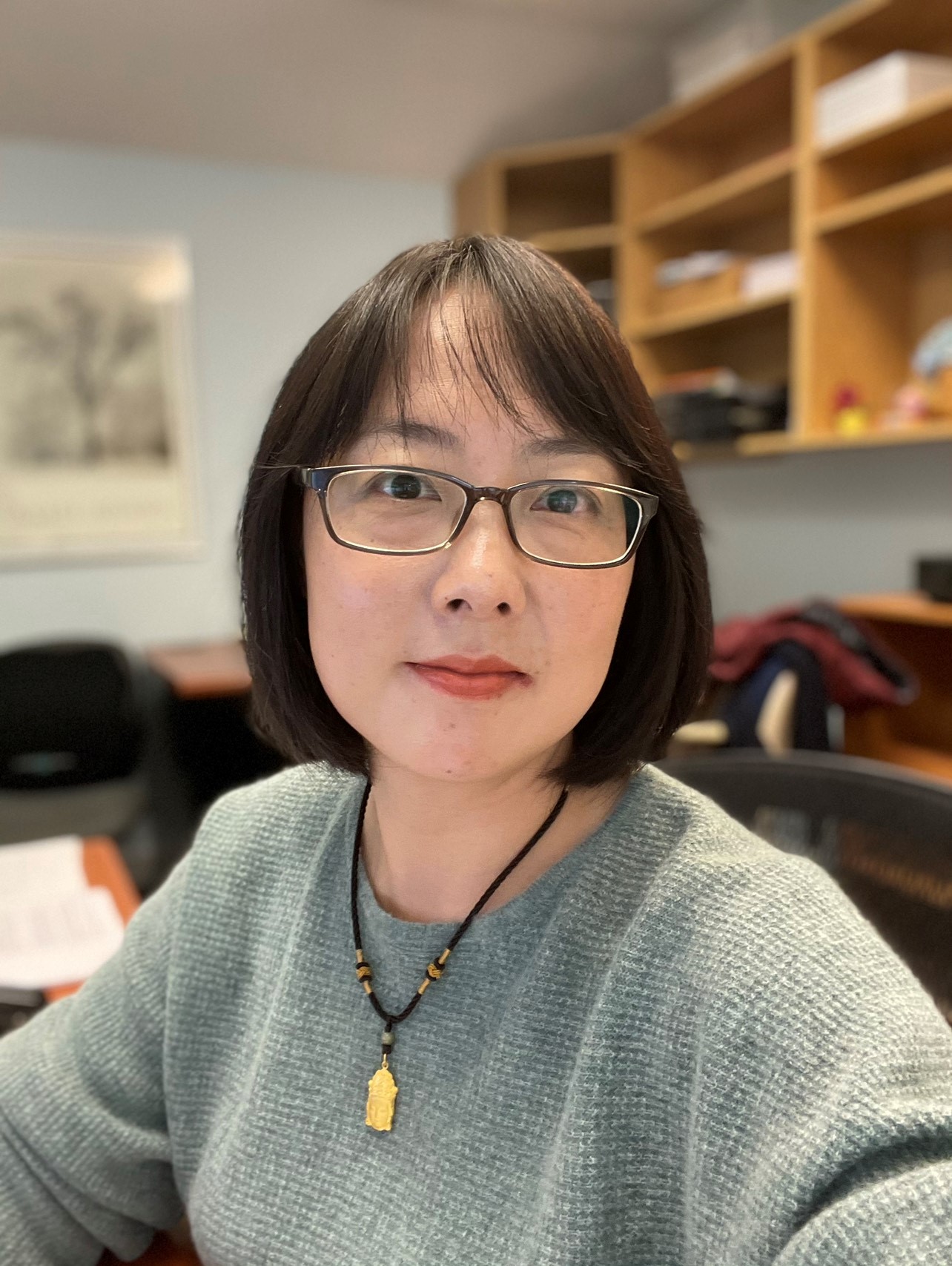 Wei Zhang in grey sweater