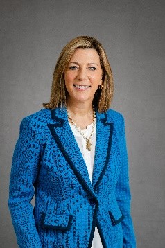 Photo of Julia Mason smiling and looking at the camera wearing a blue jacket