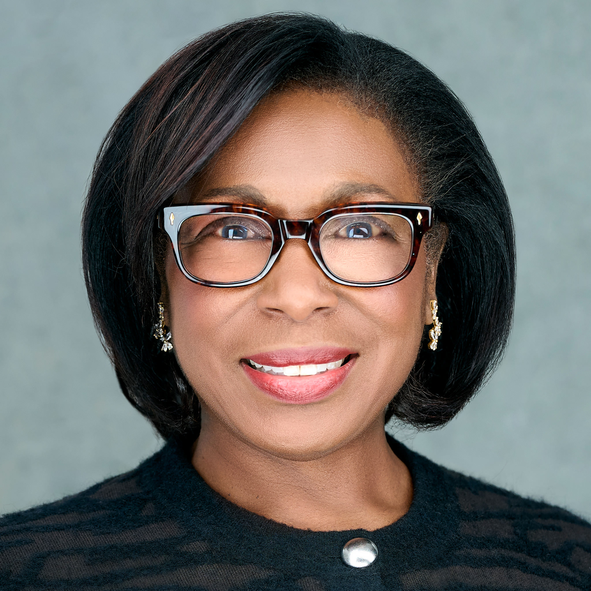 Headshot of Michele Courton Brown wearing glasses, smiling, and looking at camera