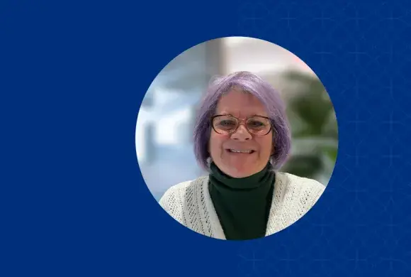 paula has purple hair and dark red rimmed glasses