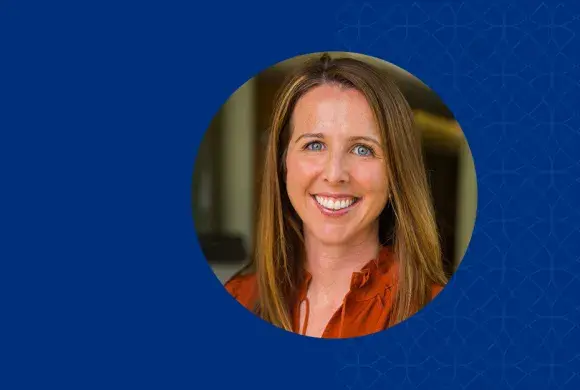 Women with dark blonde hair smiling and wearing a red shirt