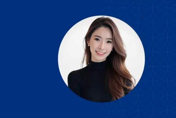 Woman with long brown hair smiling and wearing a black shirt