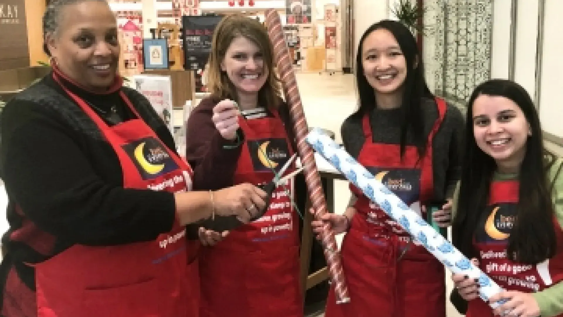 Joan Blue, Luella Benn, Lindsey Lo, and Arwa Jivanjee were among the IHP staffers who wrapped presents at CambridgeSide Galleria.