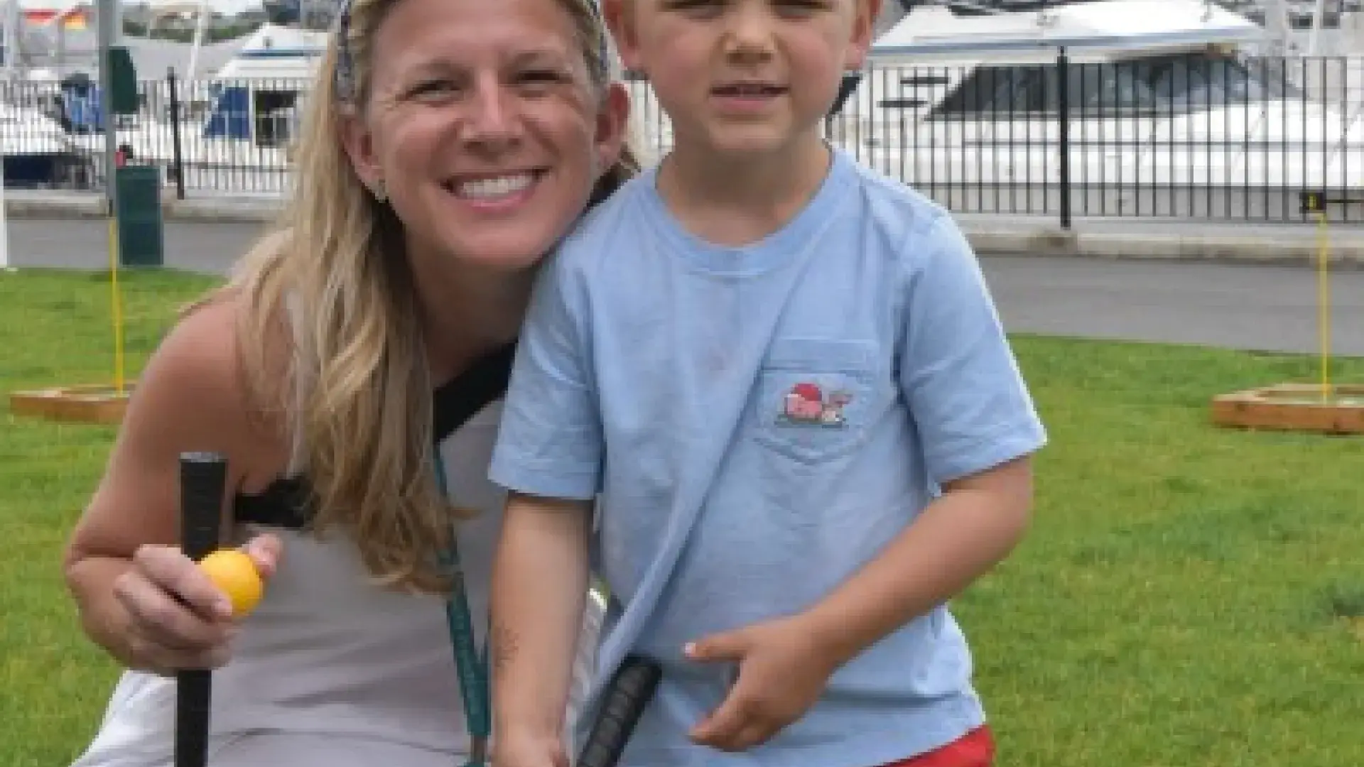 Sarah McKinnon, Assistant Professor of Occupational  Therapy and her son play mini golf.