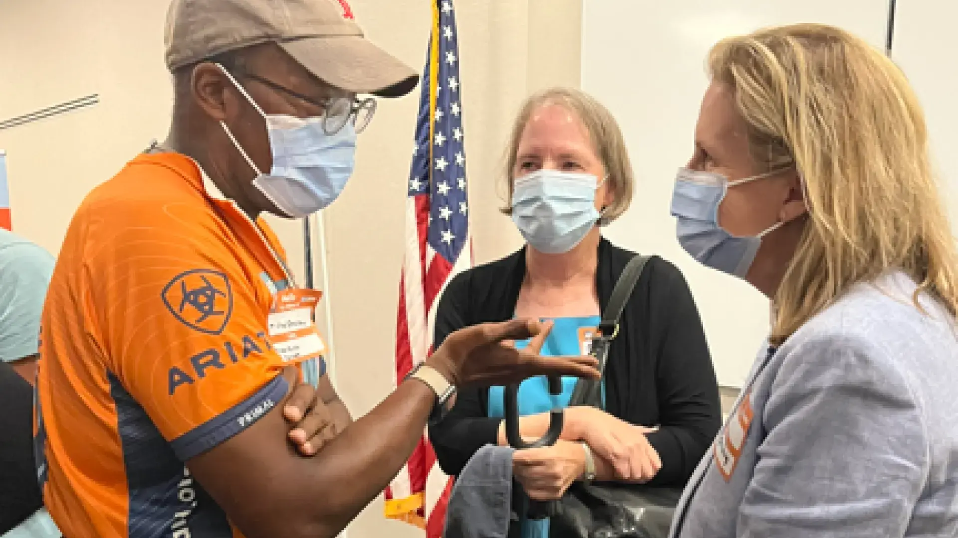 Obel-Omia speaks with members of his former care team at the celebration event, including Dr. Marjorie Nicholas of the IHP.