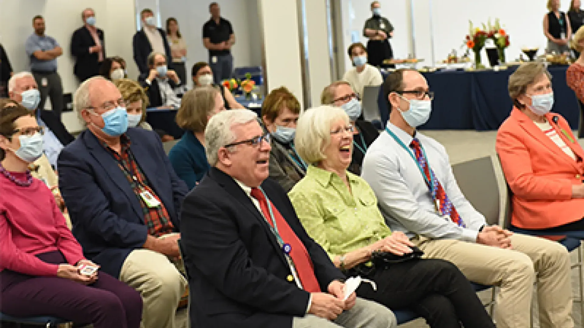 Dr. Alex Johnson and wife Linda sharing a laugh during remarks given by Director of Academic Operations Heather Anne Easter.