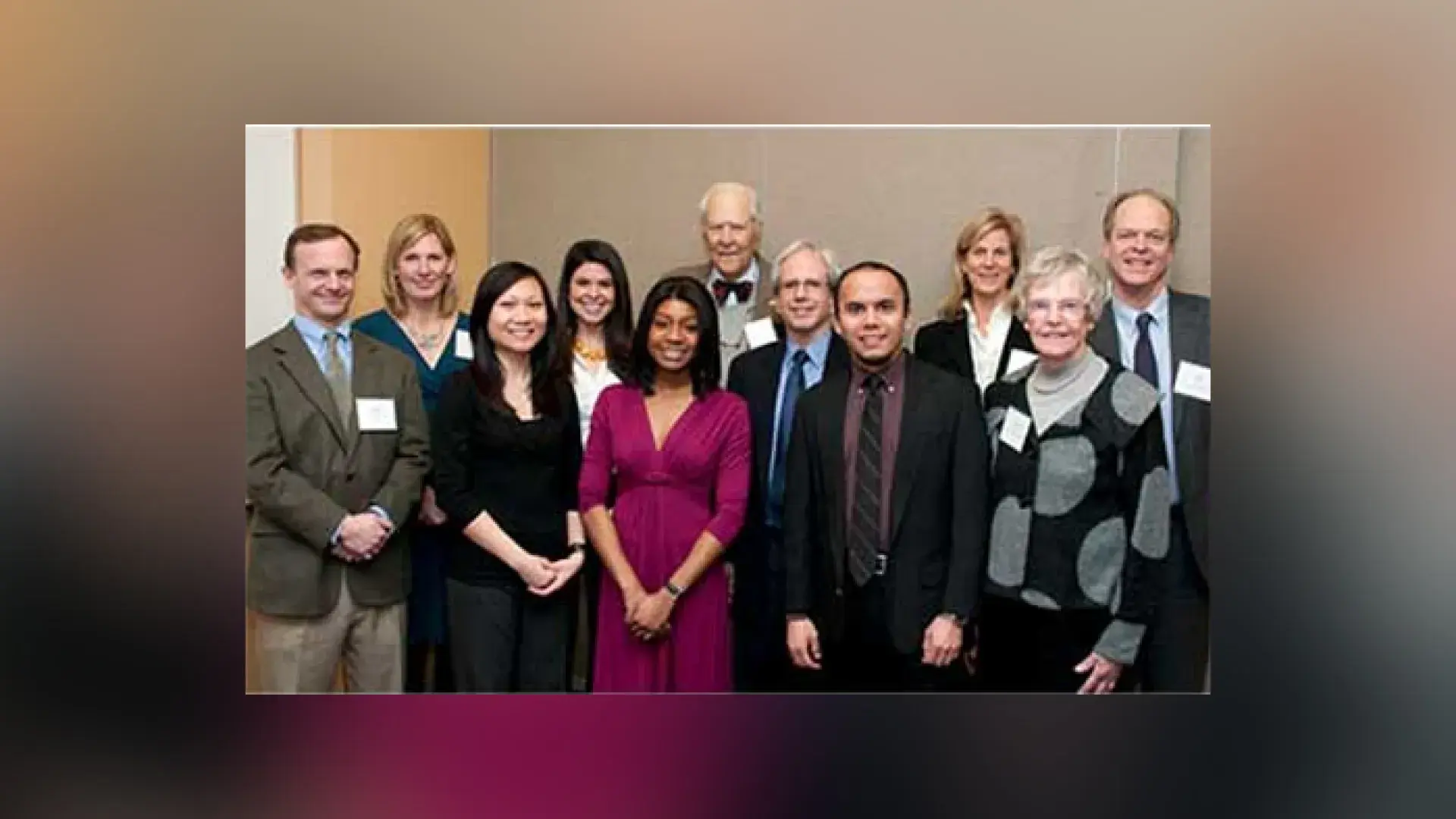 group of people stand together in formal attire