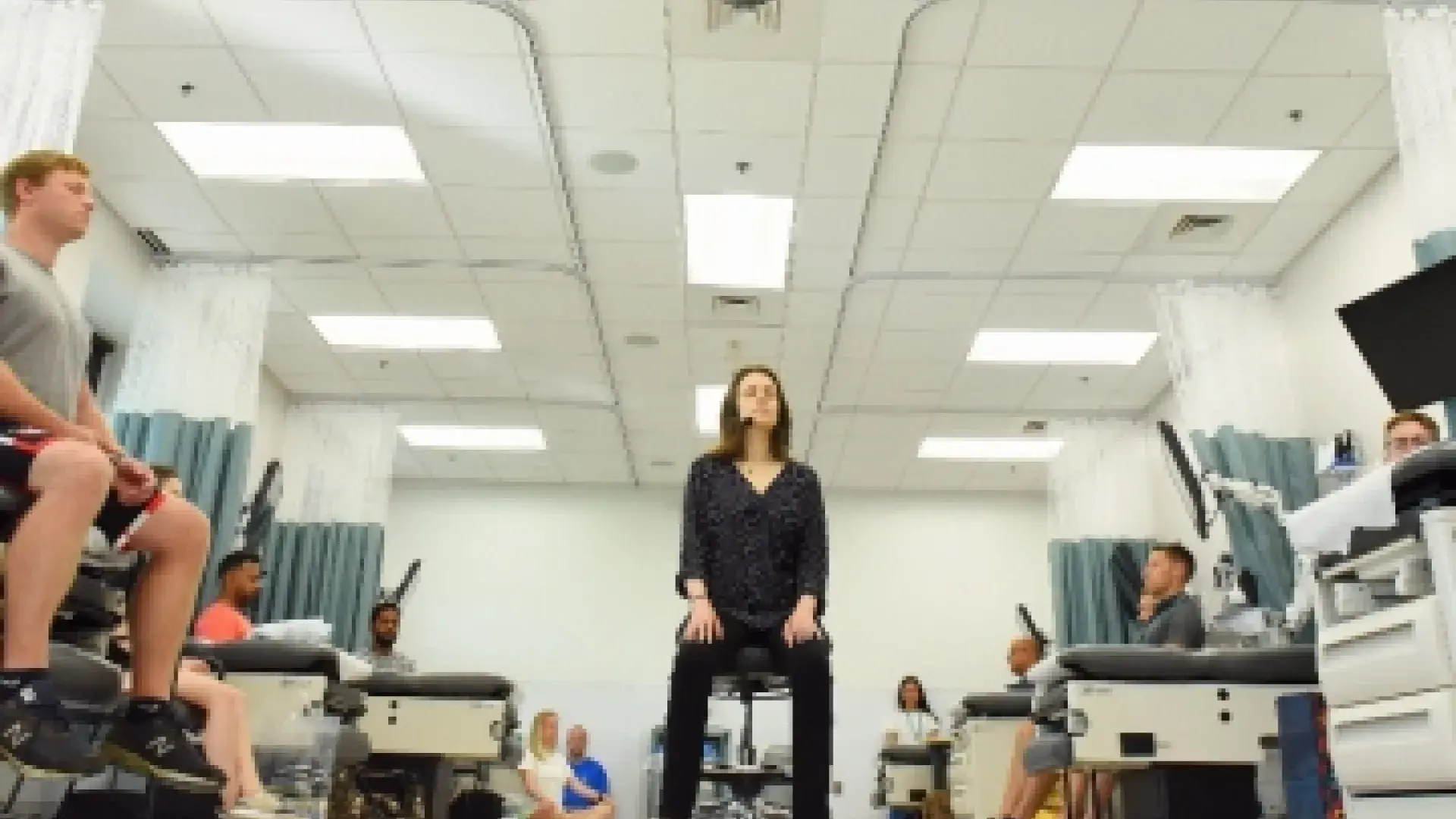 Meghan Viveiros, an instructor of physician assistant studies, begins her class by guiding her students into a state of relaxation.