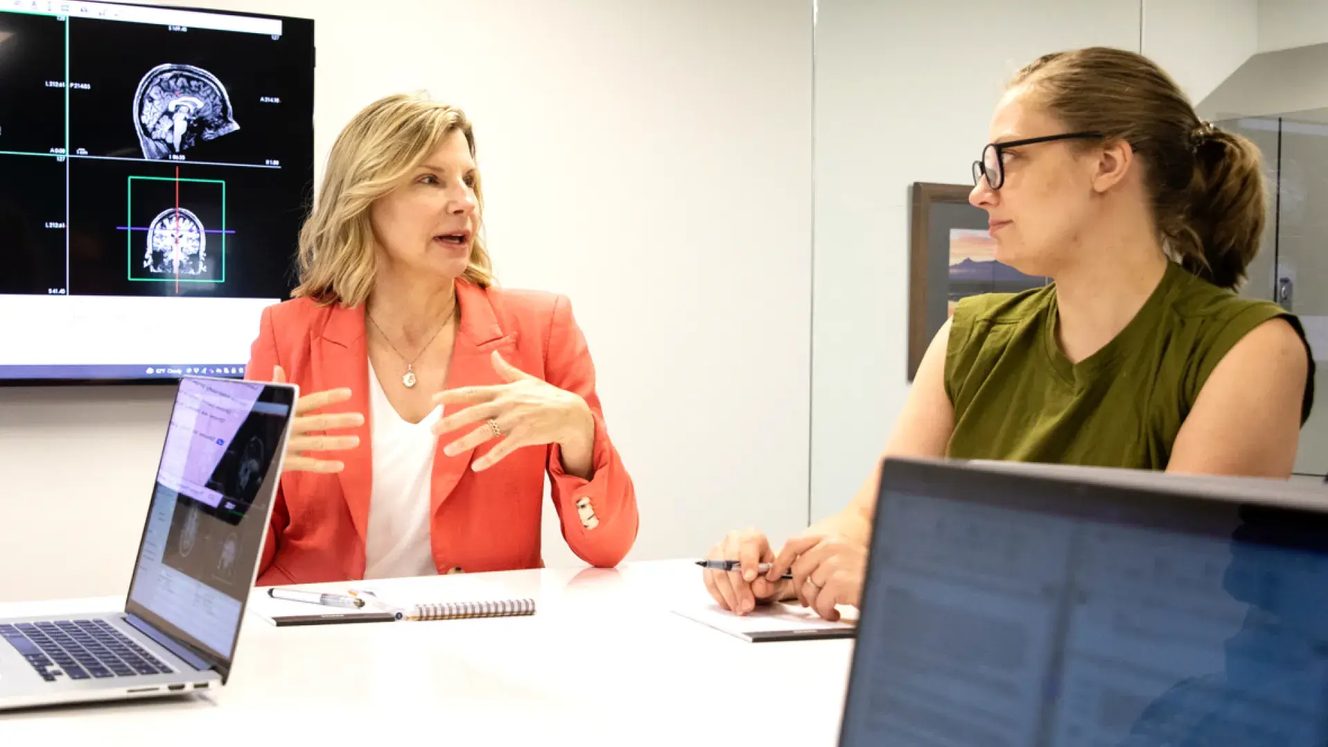 Two woman sitting at a table having a discussion