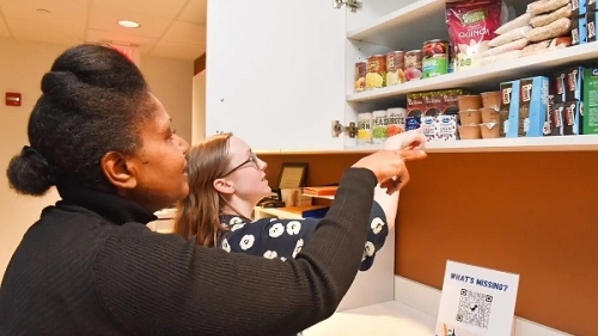 Students Phyllis Wallace MSN'24 & Kira Kearney OTD '22 check out what's available at the IHP Community Pantry​​​​​​​.