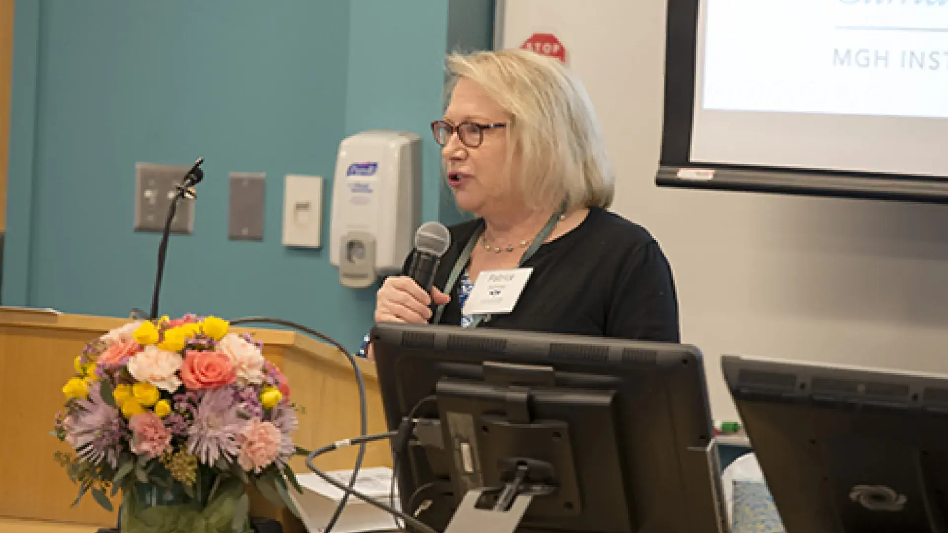 A woman speaking on a microphone