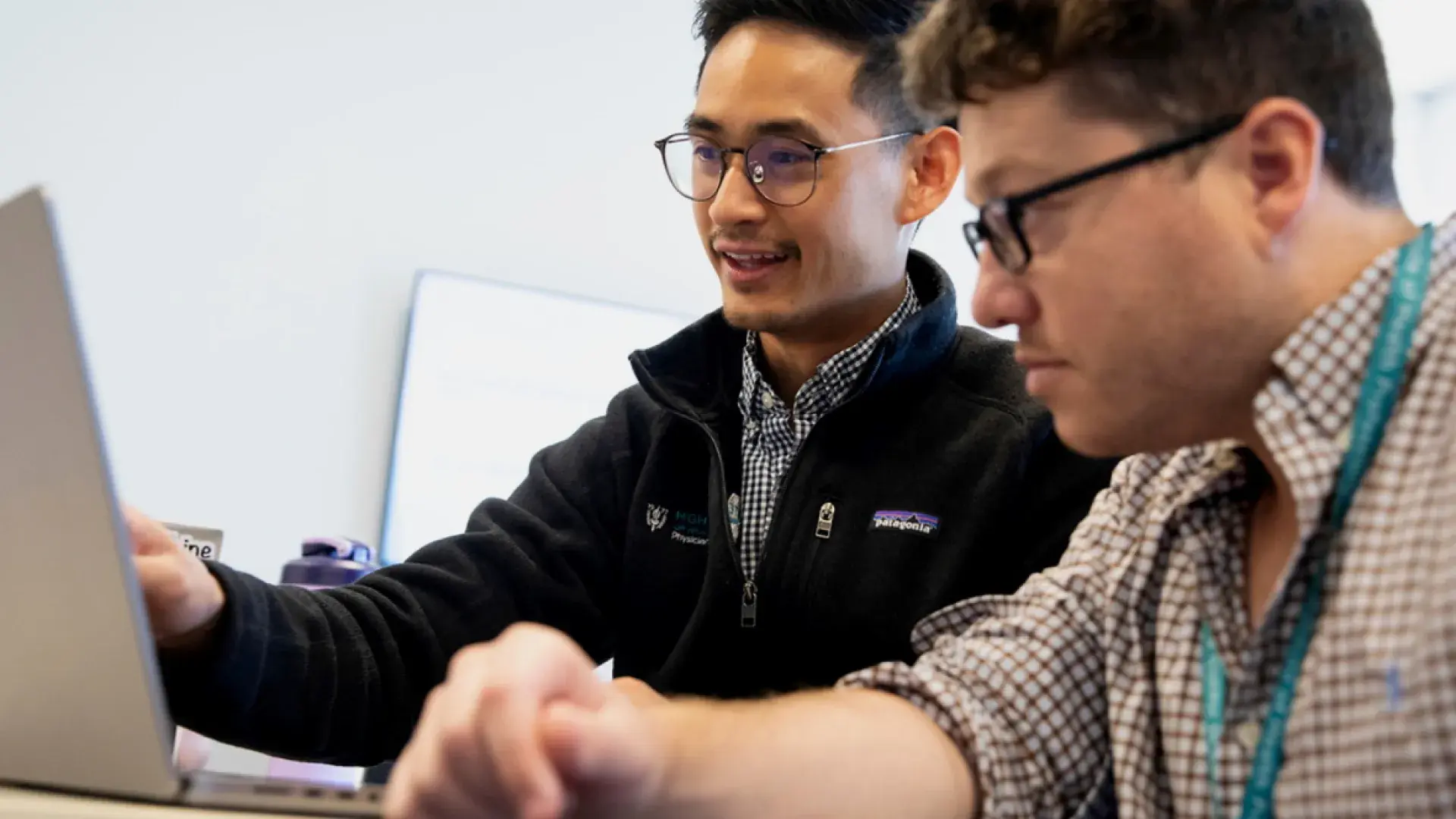 Two students working on a computer together