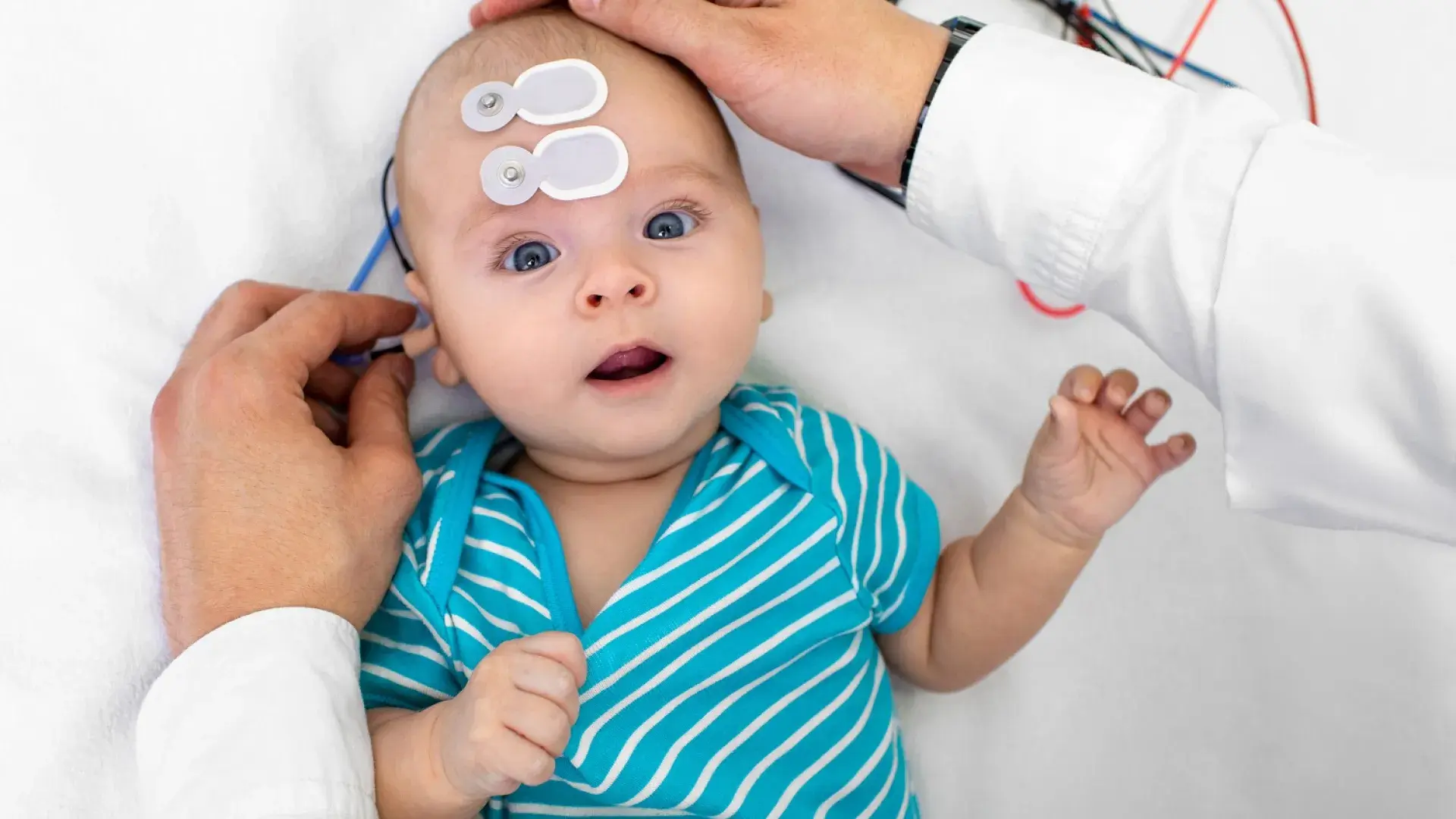 An audiologist conducting a hearing assessment on an infant, demonstrating the MGH IHP Doctor of Audiology program's focus on clinical expertise.
