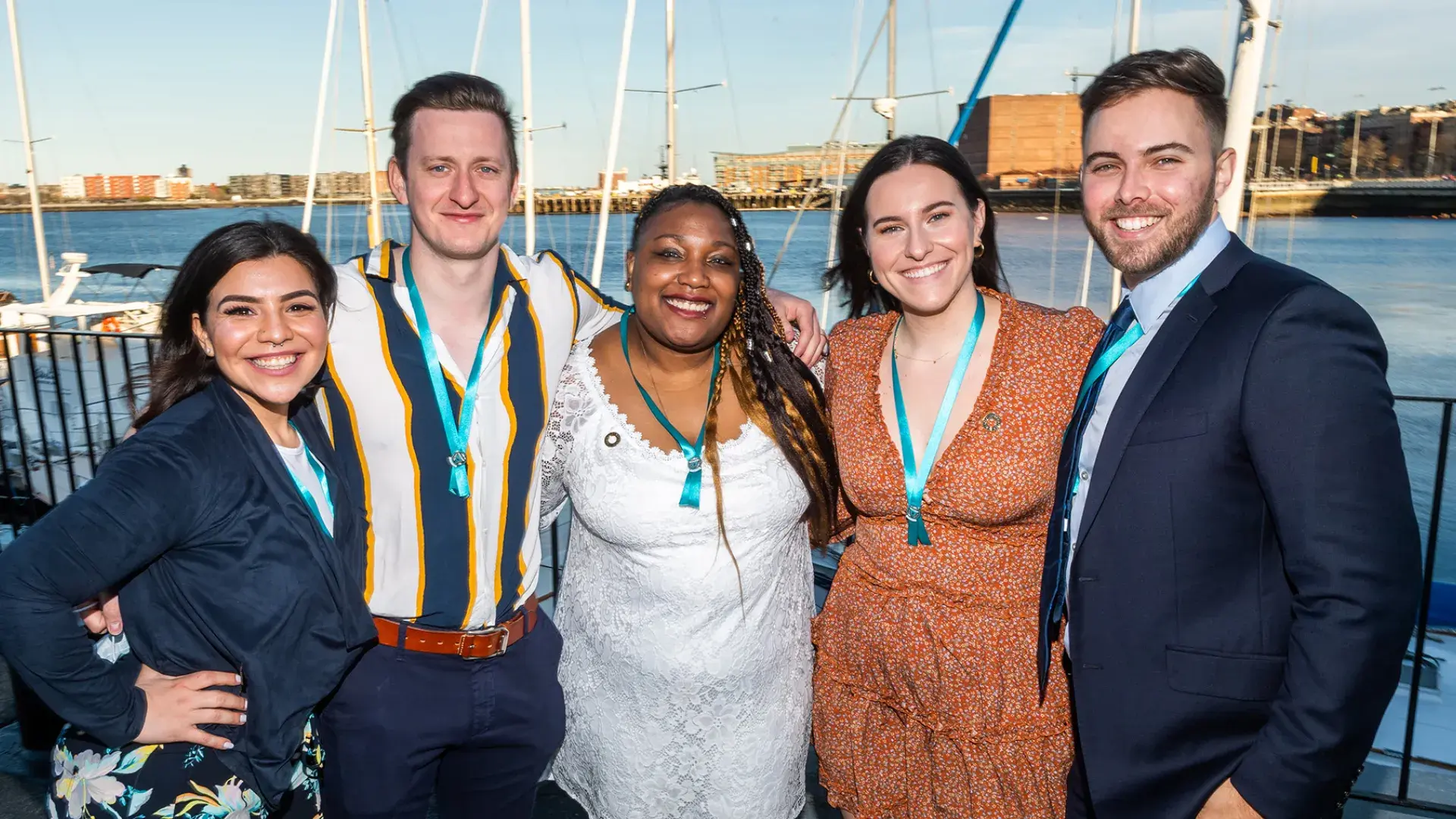 group of men and women in dressed up attire smile for the camera