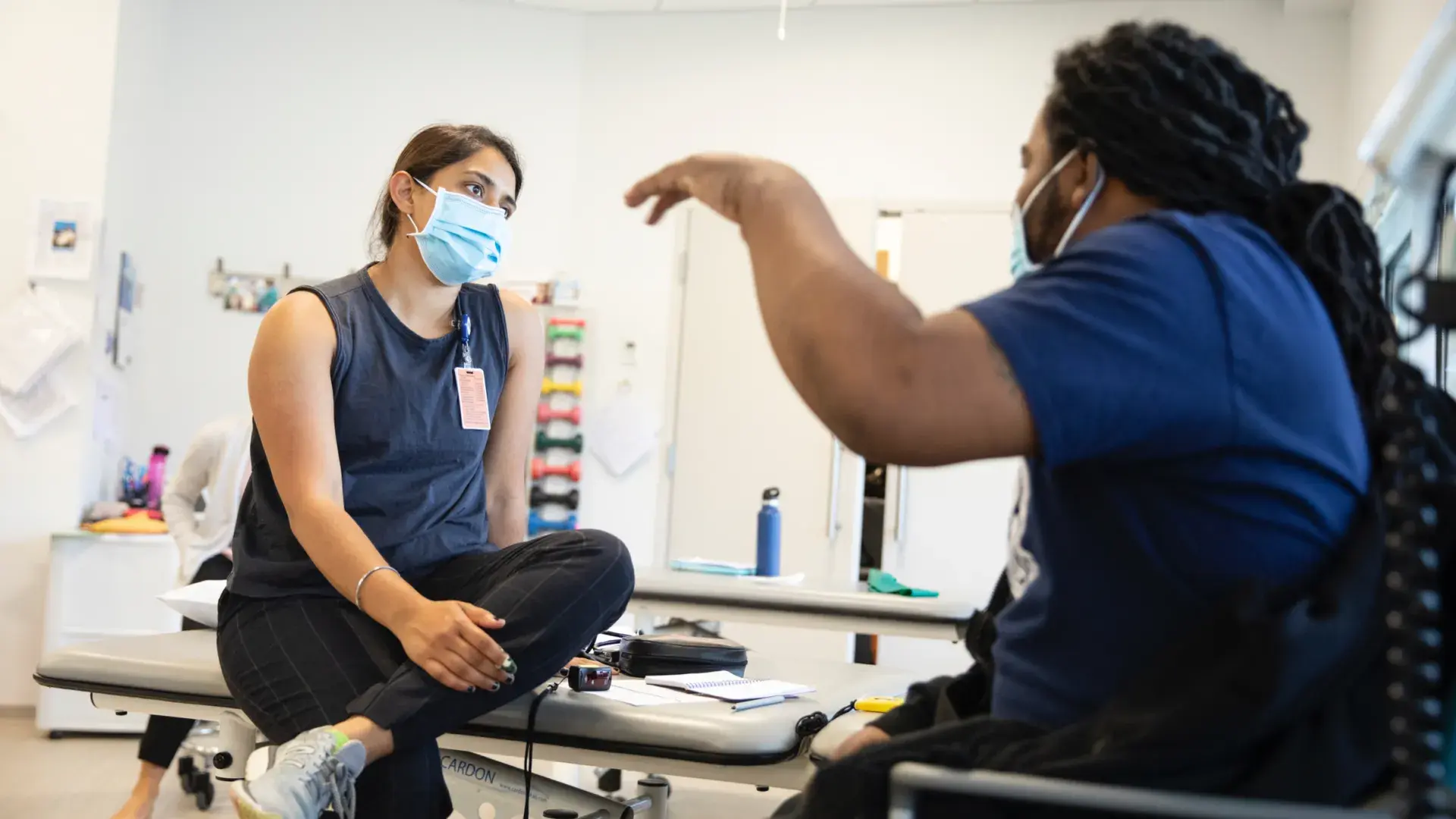 A medical professional having a conversation with a patient