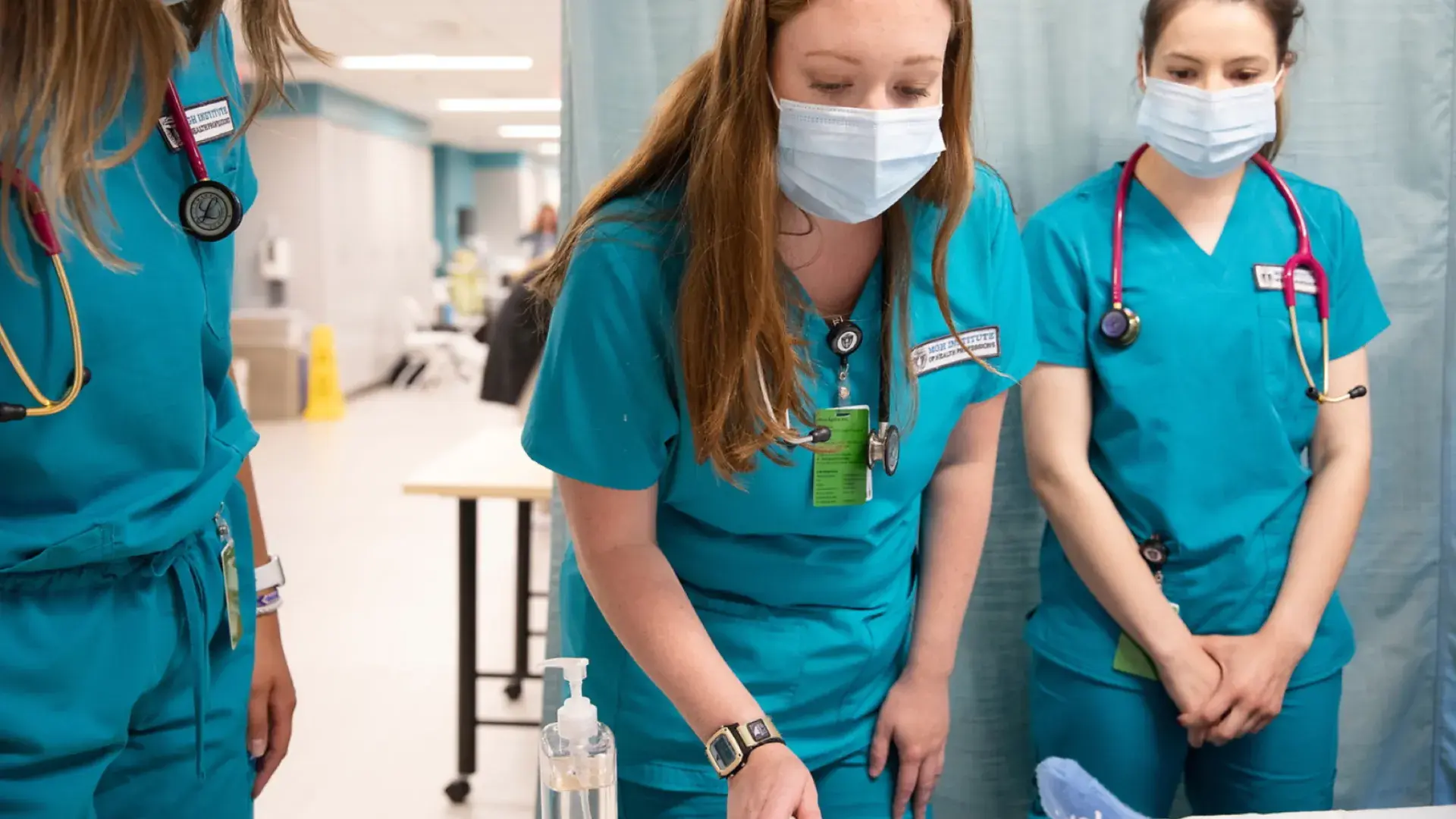 Three students working in the simulation lab.