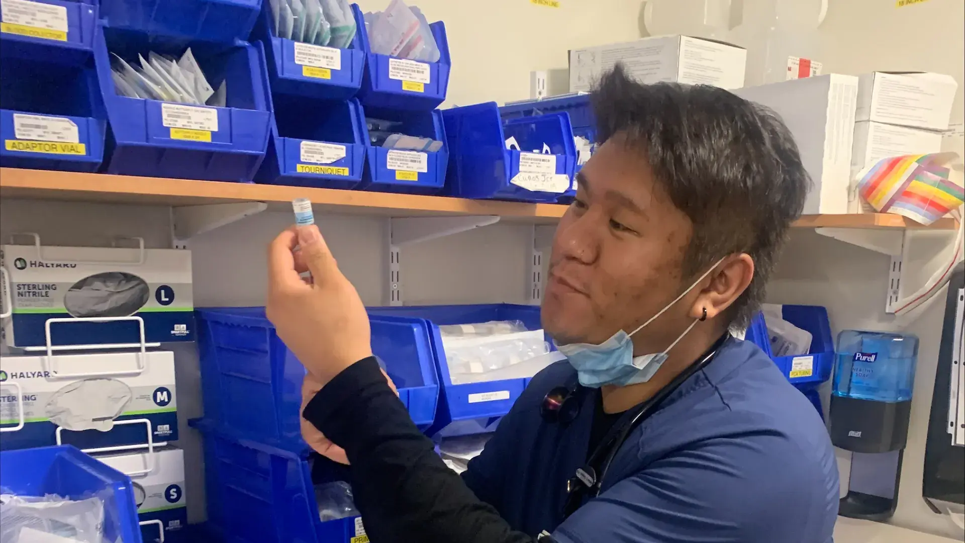 A nurse prepares a syringe.