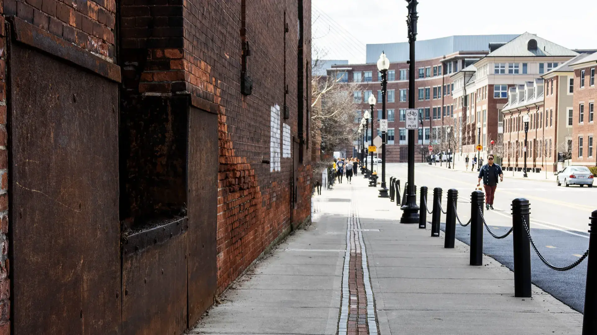 sidewalk with brick path down the center of it