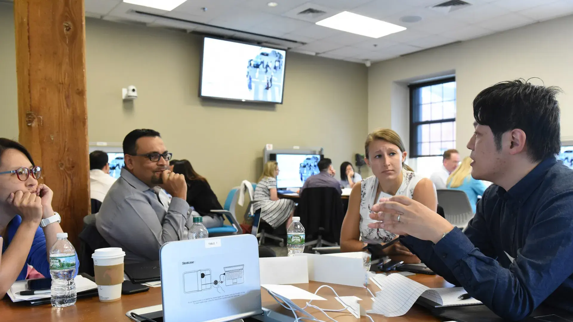 students around a table in a classroom