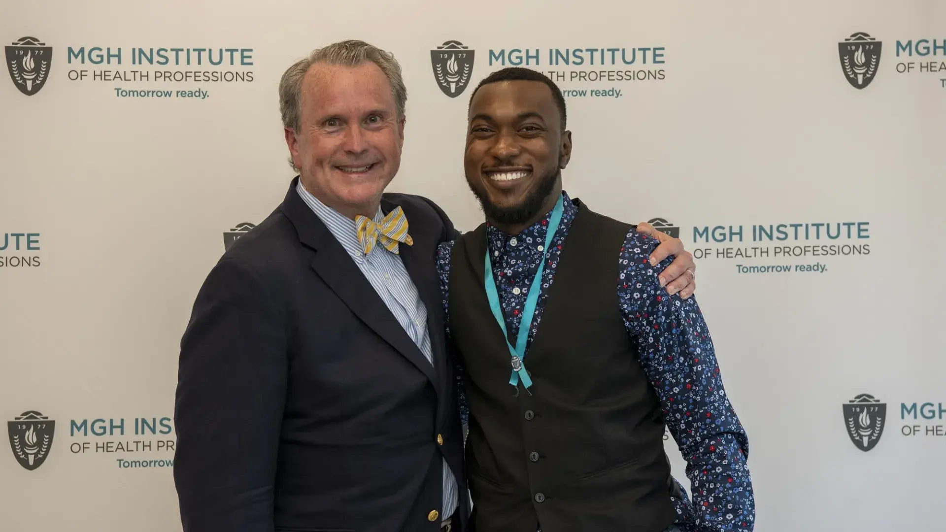 Dean White (left) and Ian Syblis pose in front of an IHP background