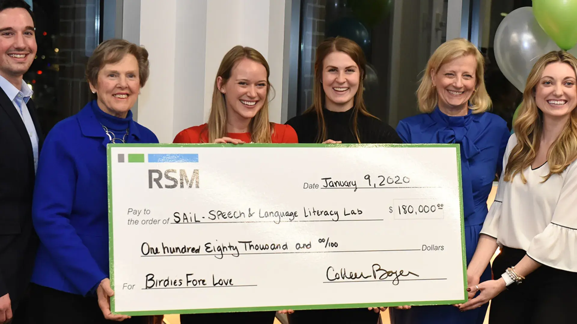 Photo of Patrick O’Neill of RSM, IHP President Paula Milone-Nuzzo, IHP students Elise Hopkins Gallegos and Alexandra Hanson, IHP Chief Development Officer Clare McCully, and Erinn Johnson of RSM, holding a large check