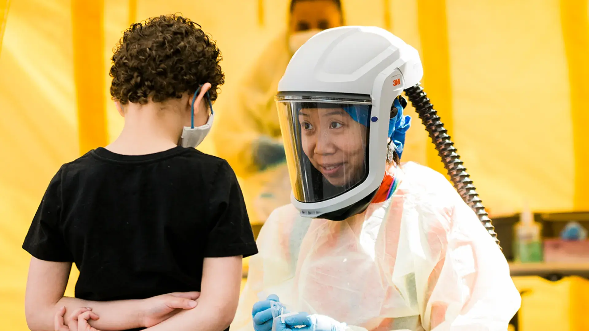 Photo of Julie Chan working with a young patient at the Lynn Community Health Center