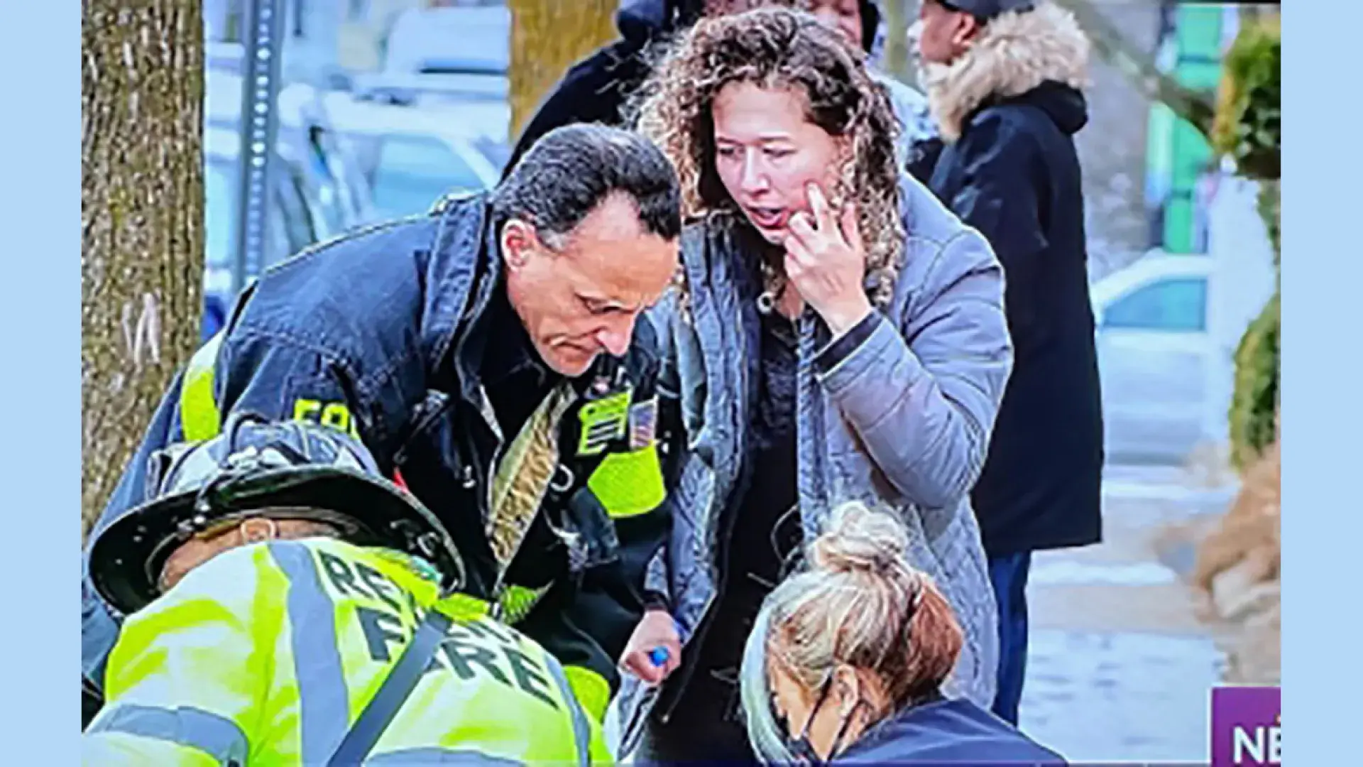 Kezia Pereira, BSN '22, talks to safety officials outside her Revere home.