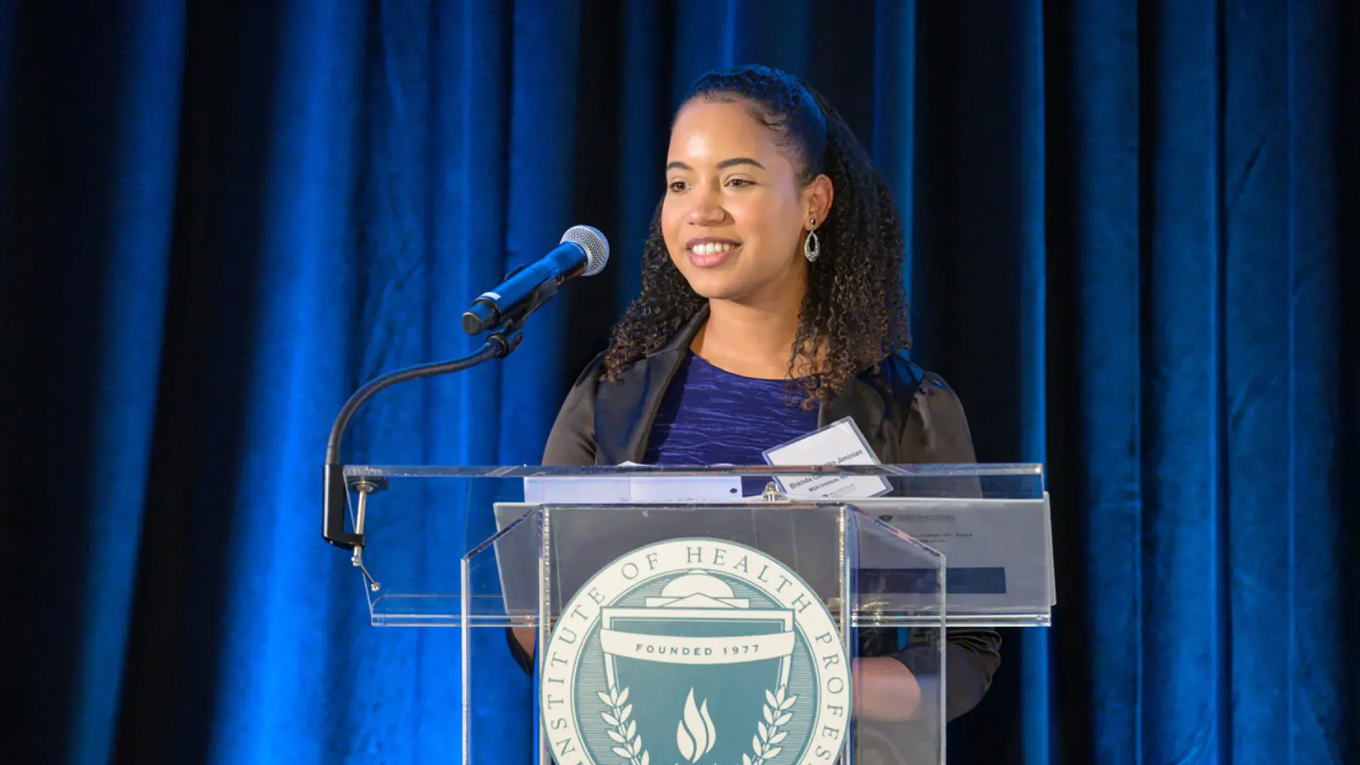Brenda Castillo Jiminian, recipient of the Charles and Ann Sanders Interprofessional Scholarship, addresses audience members at "The IHP Today: Bridging the Health Care Gap" fundraiser.