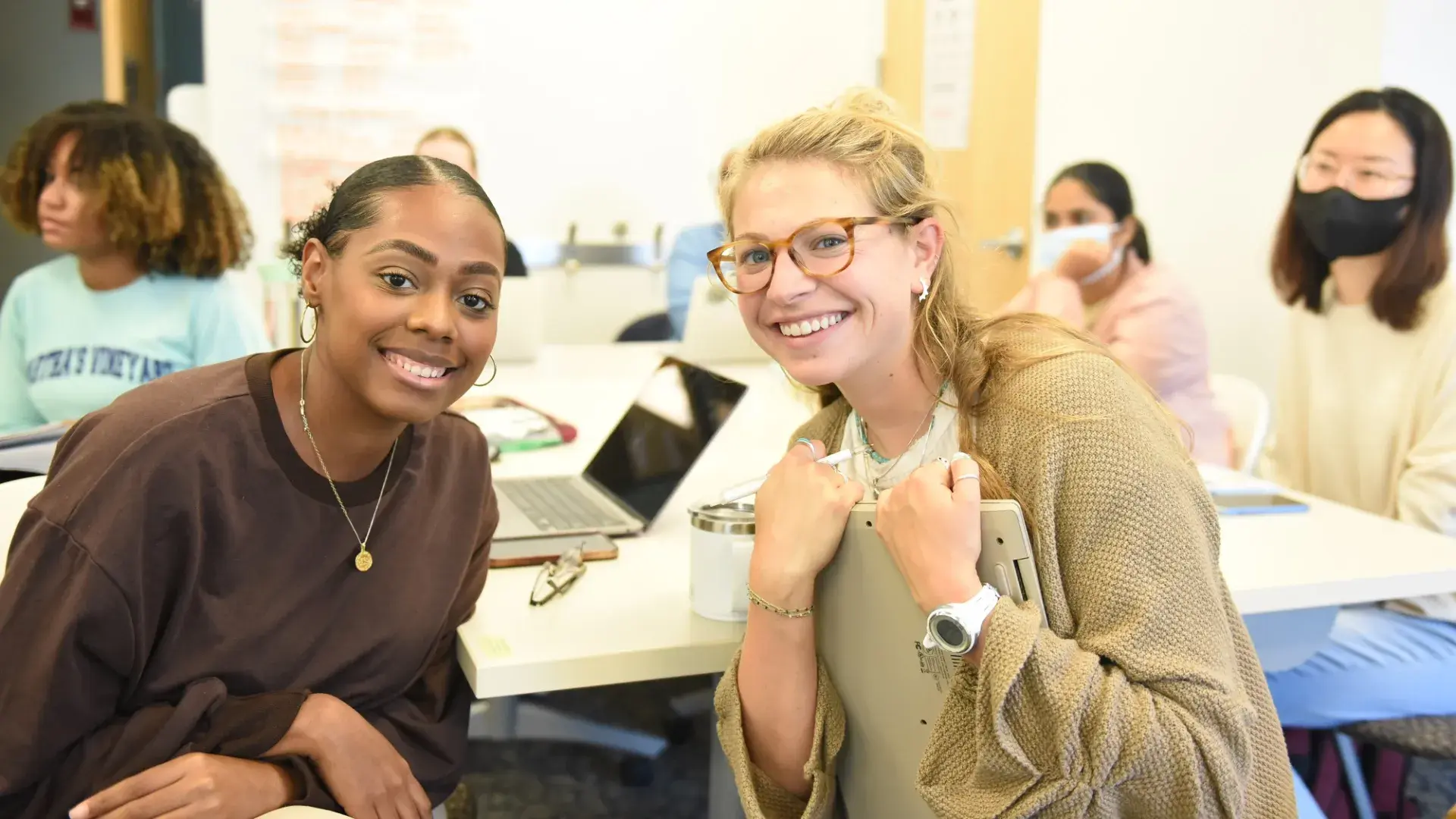 two students smile for the camera