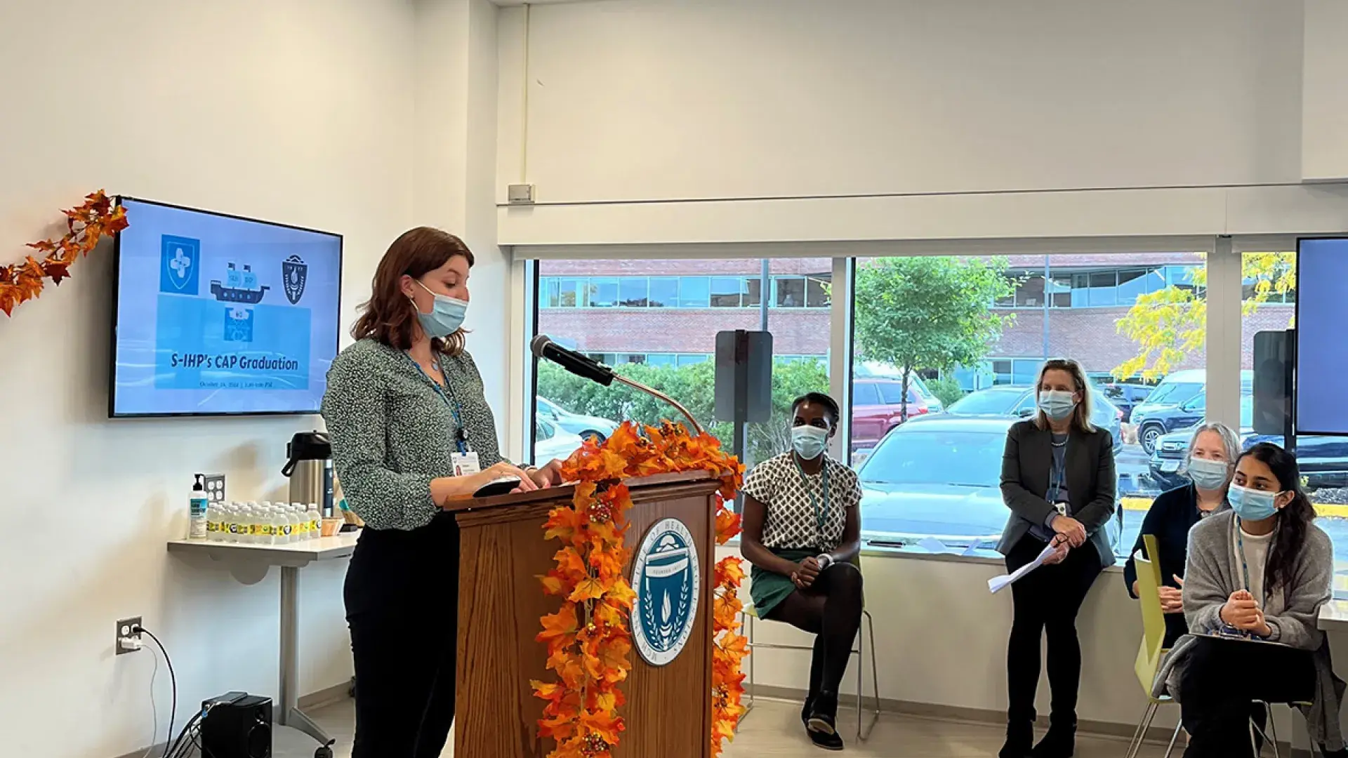 Grace Burleson, an SLP student involved in the S-IHP’s CAP program, speaking at graduation.
