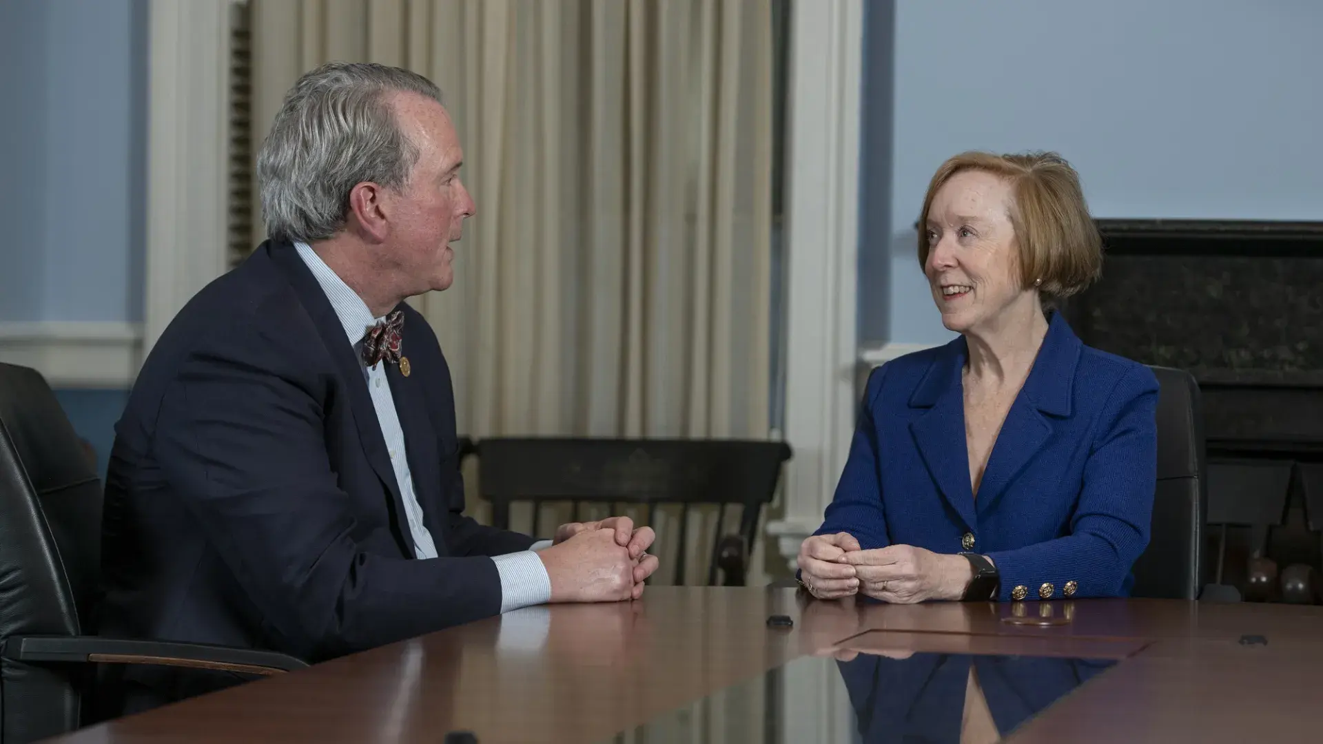 dean white and debbie burke talk across a conference room table
