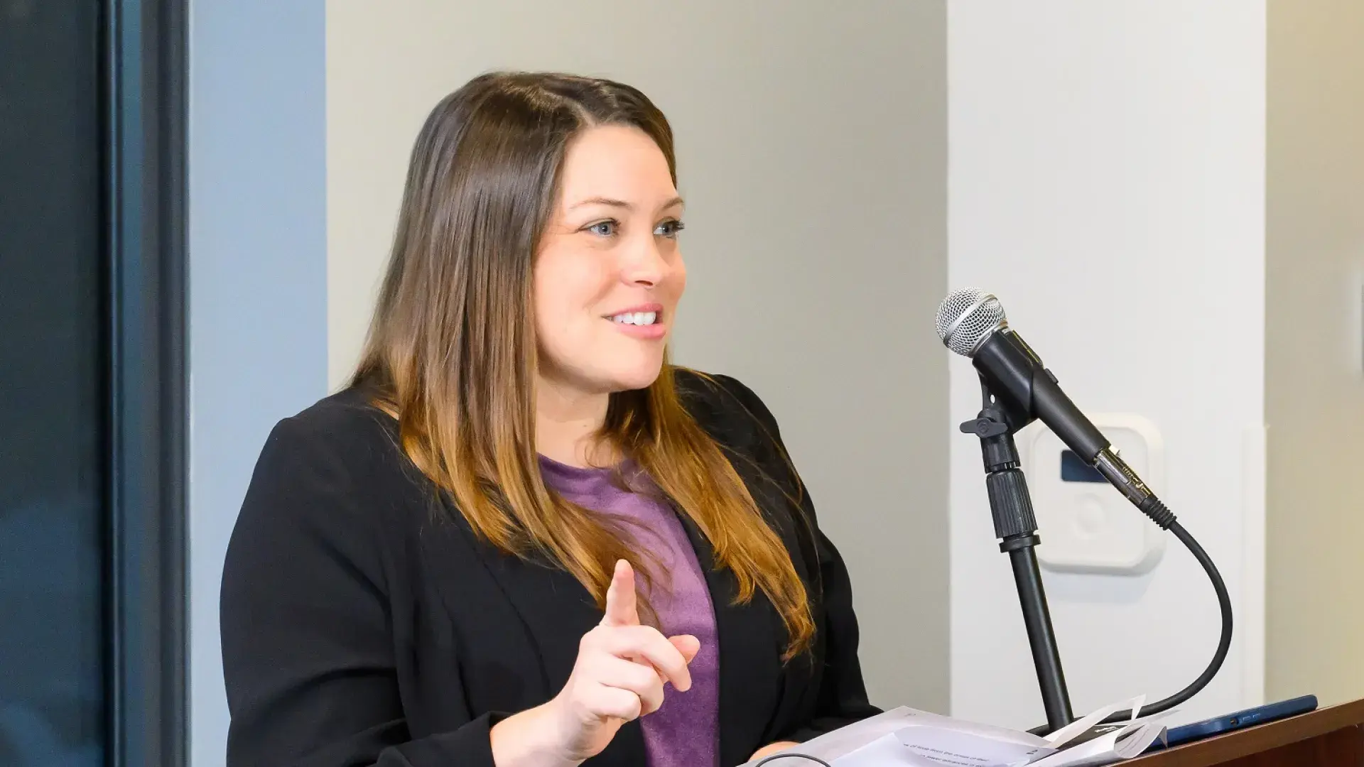 kim gestures at a podium