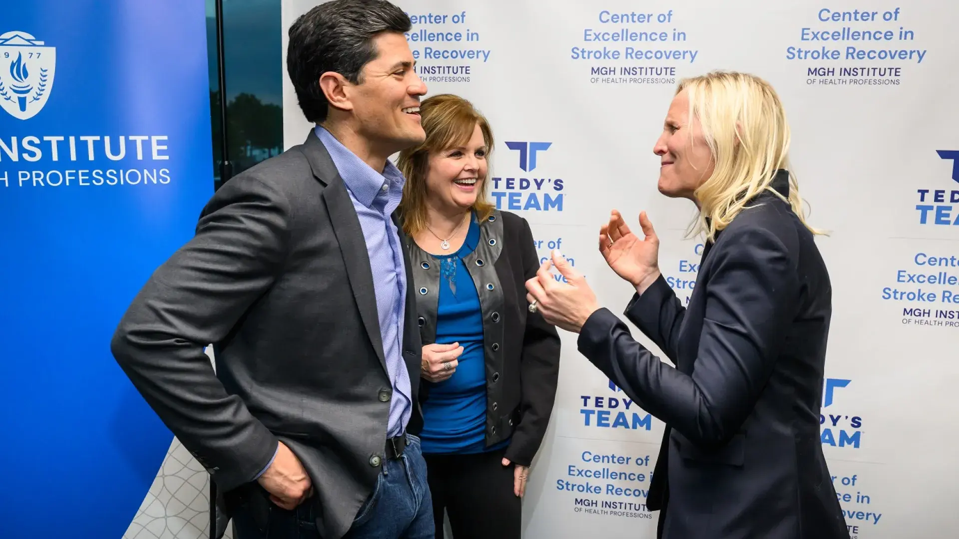 heidi laughs with her hands up while tedy and anne smile back