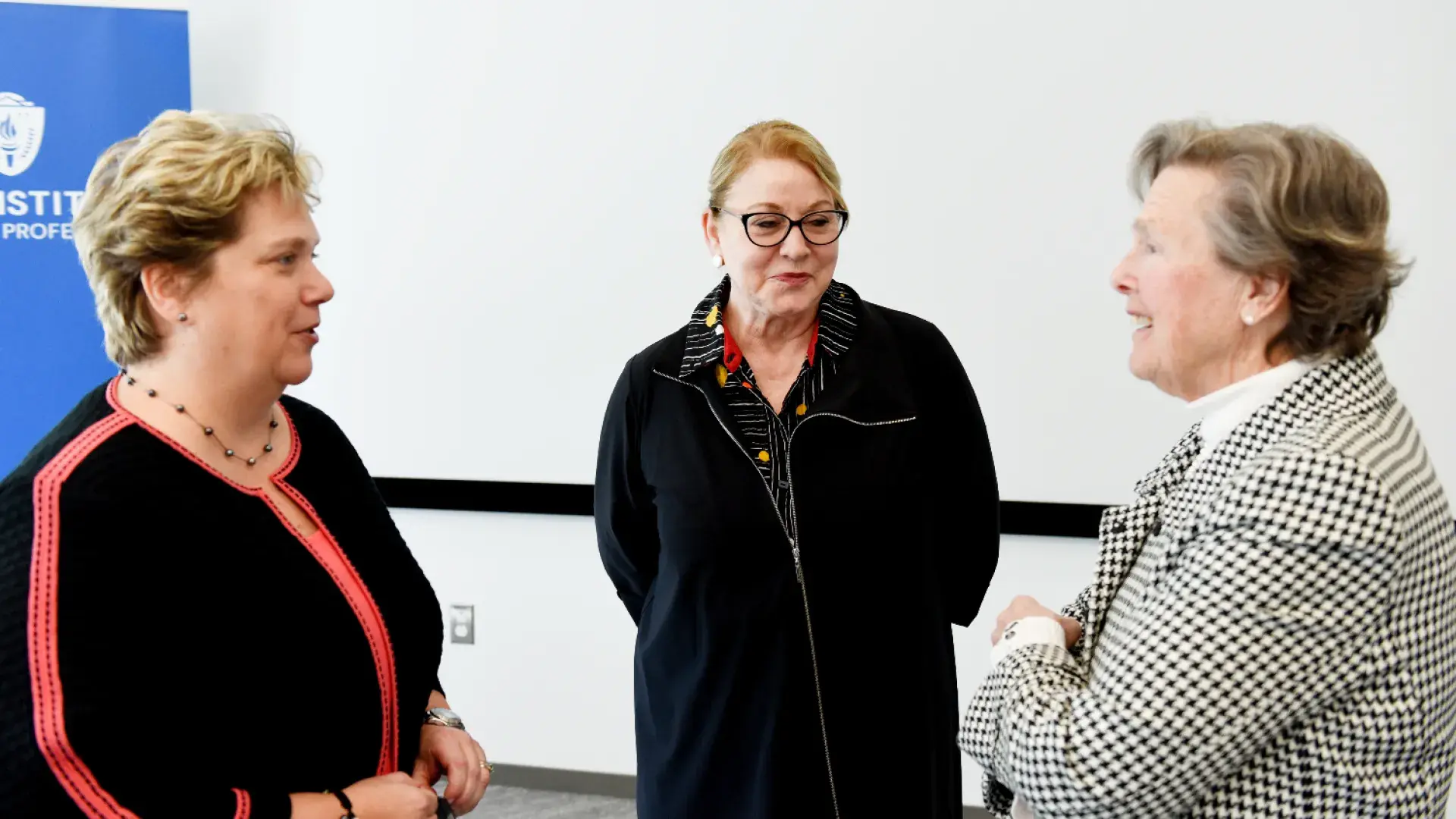 three women stand in a circle