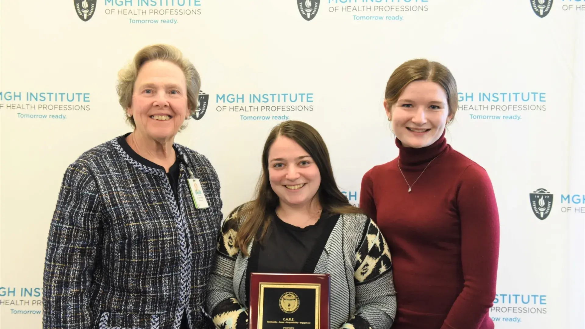 miranda holds the award while julia stands beside her