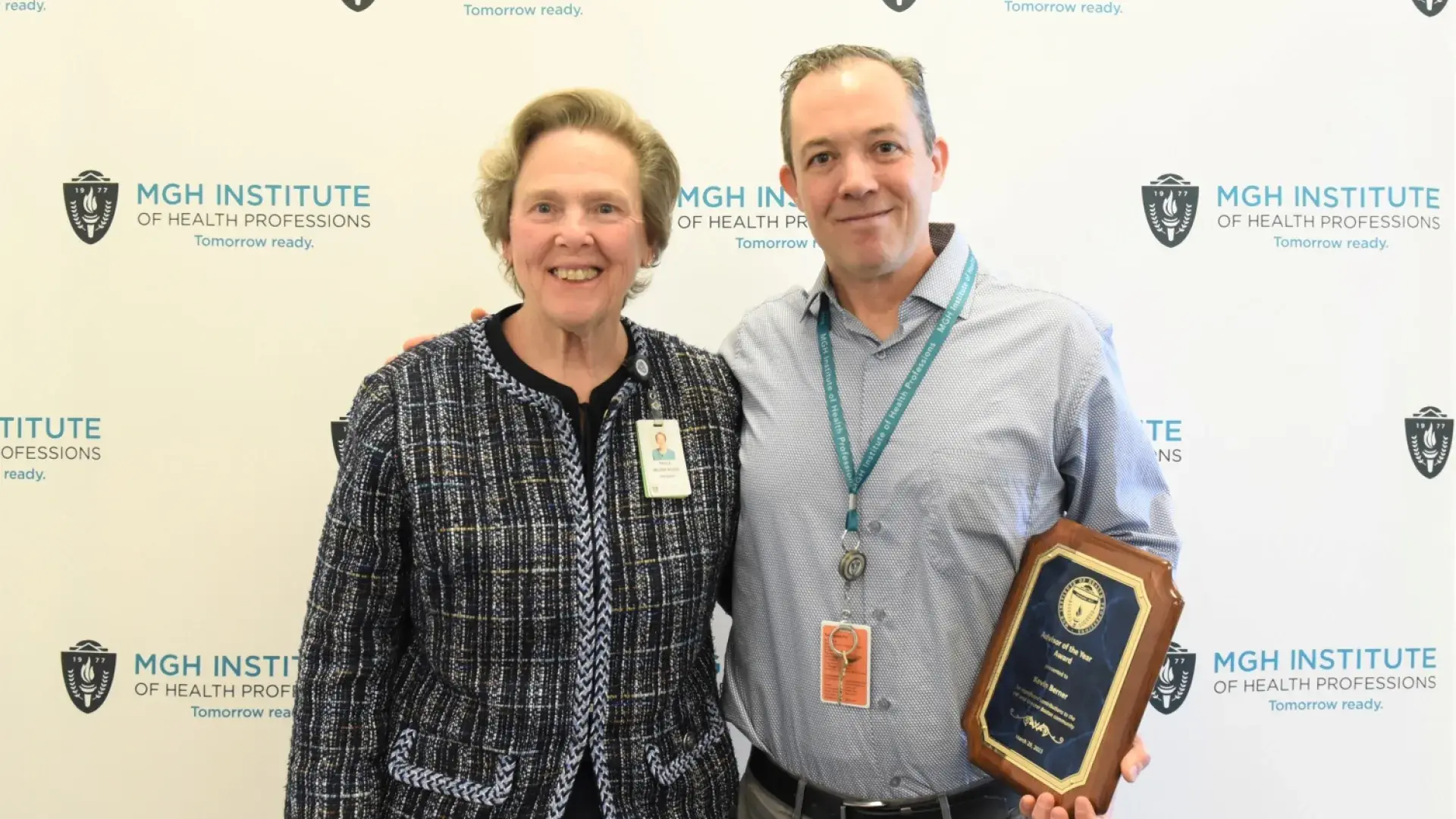 kevin holds his plaque