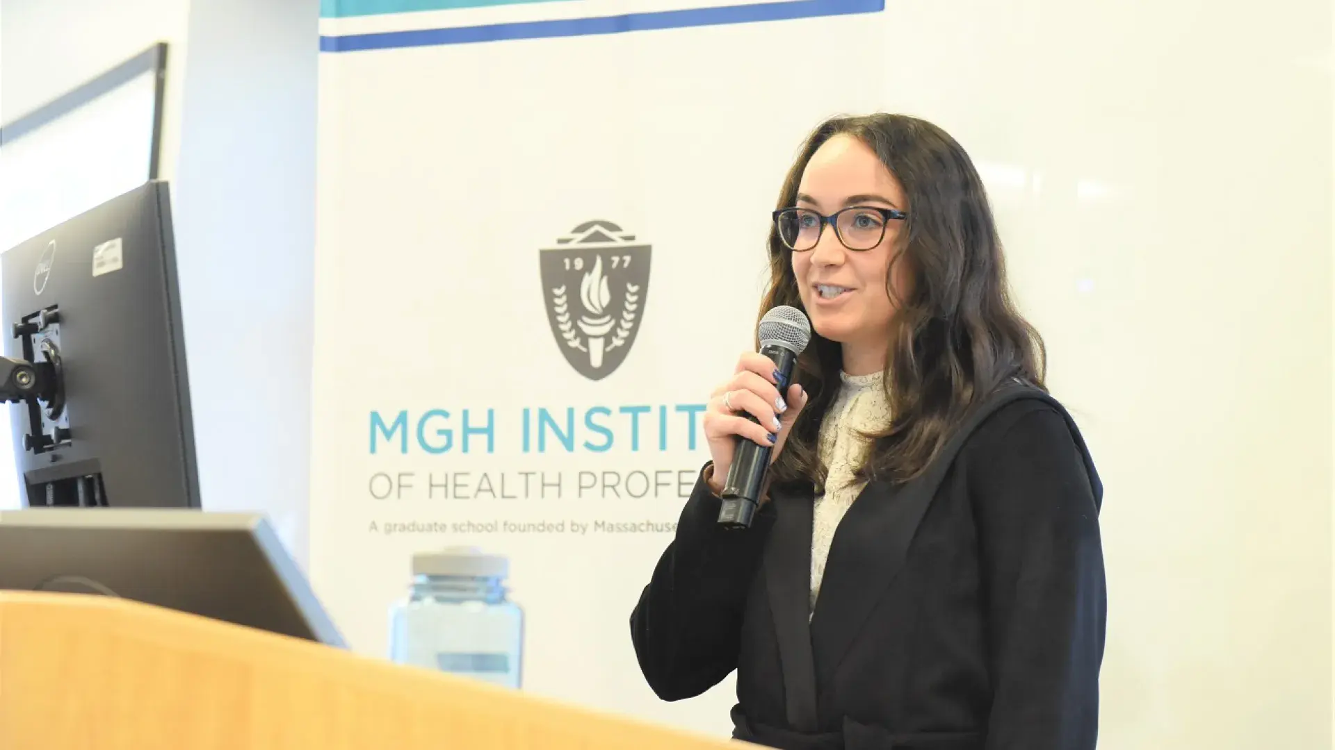 marisa holds a microphone