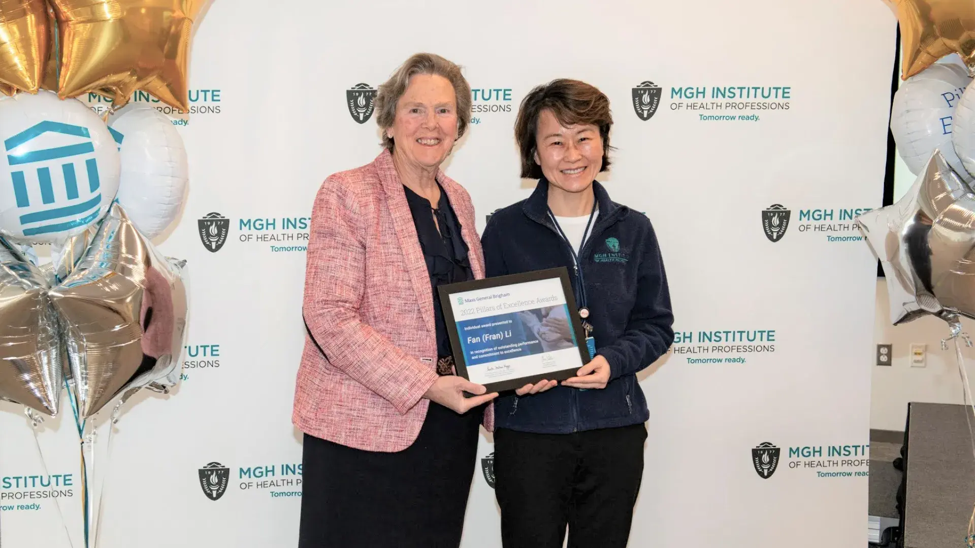 fran and paula hold an award
