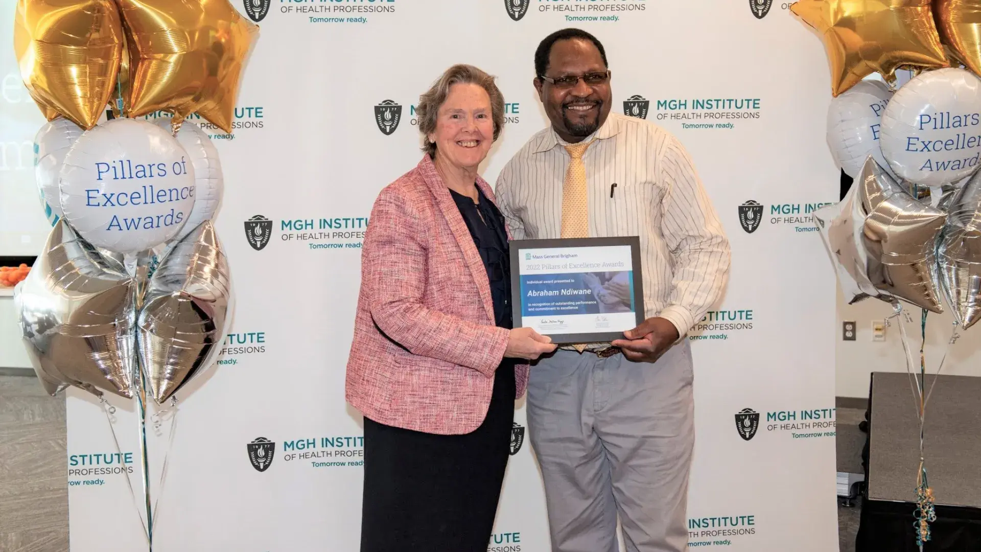 abraham holds an award 