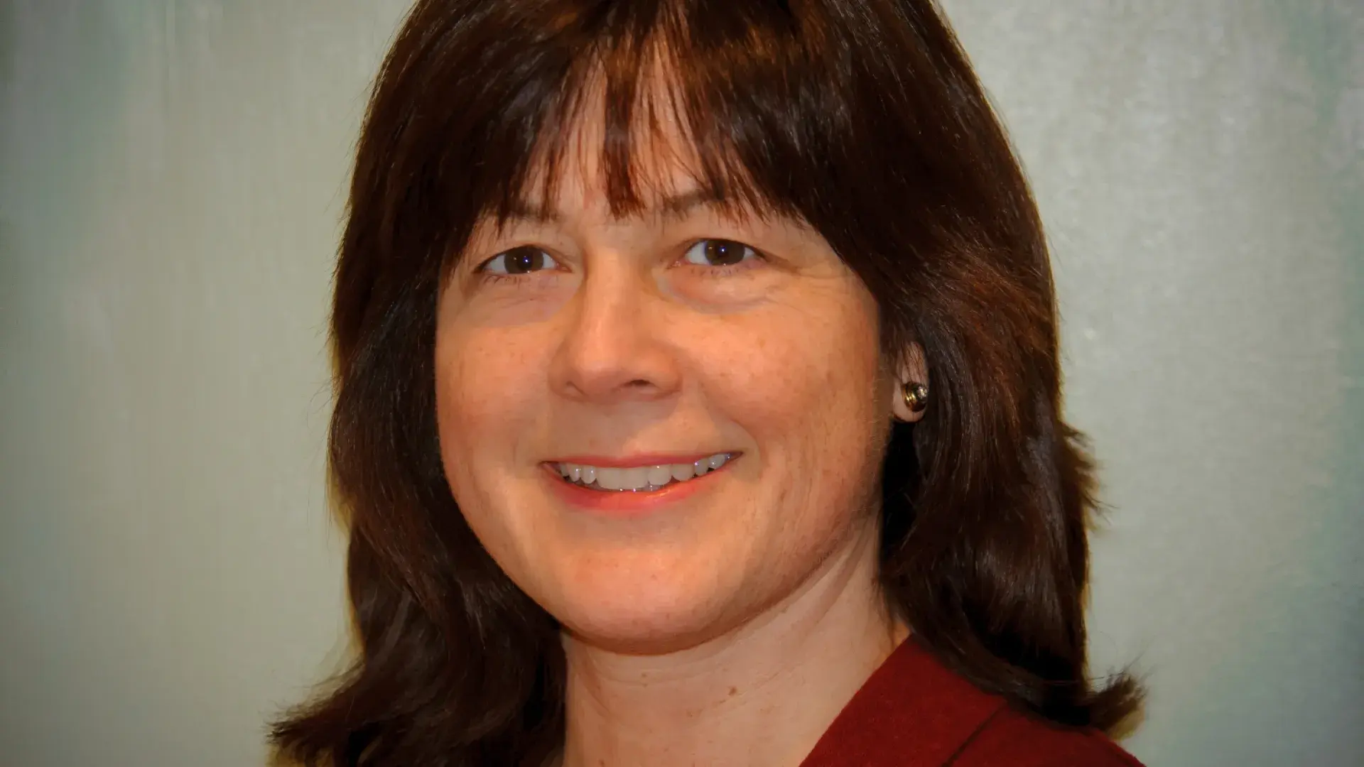 donna has shoulder length brown hair that has a little flip at the end of it