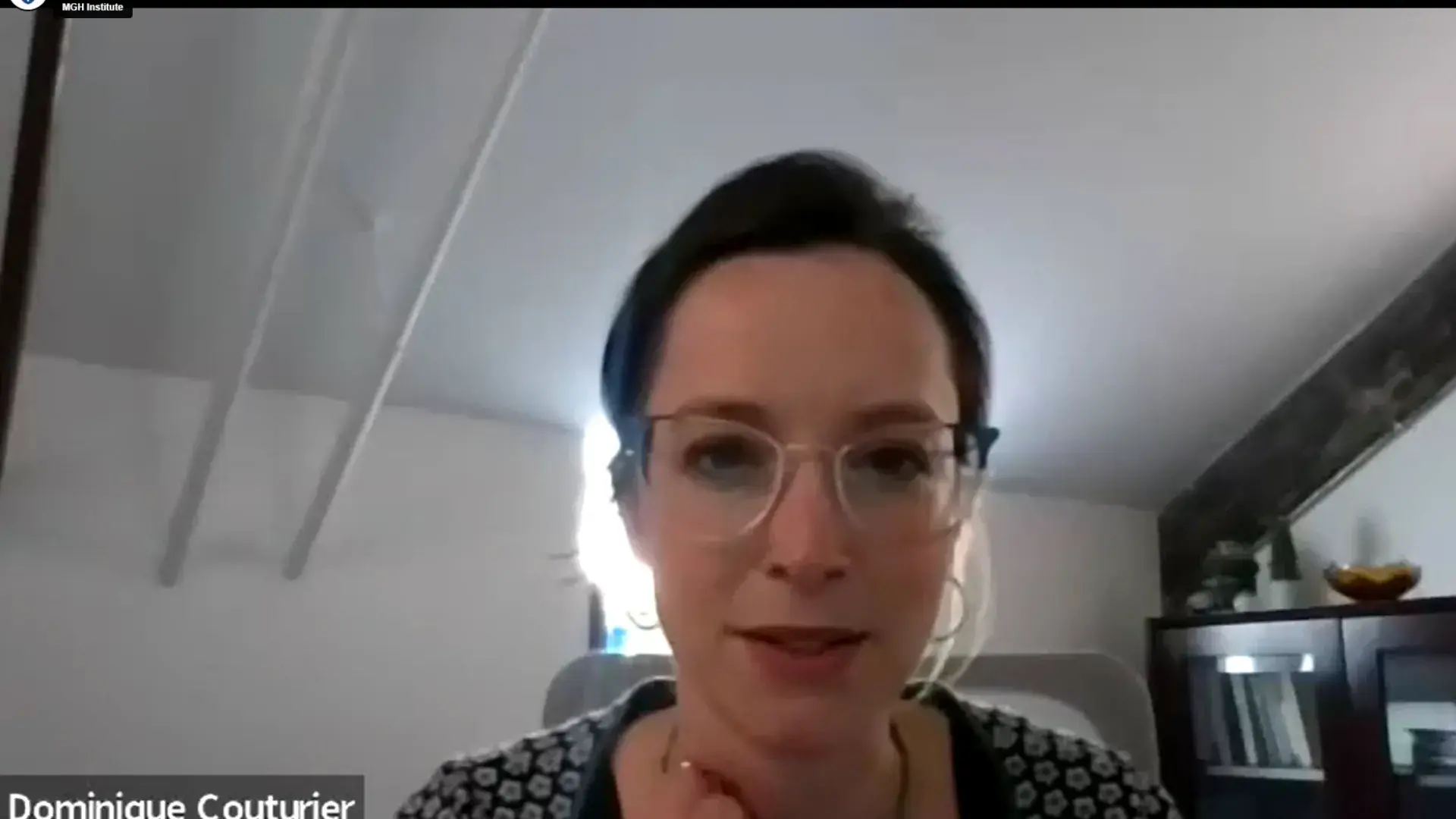 screen grab of dominique, a librarian who set up the session she wears glasses and sits in a high ceilinged space