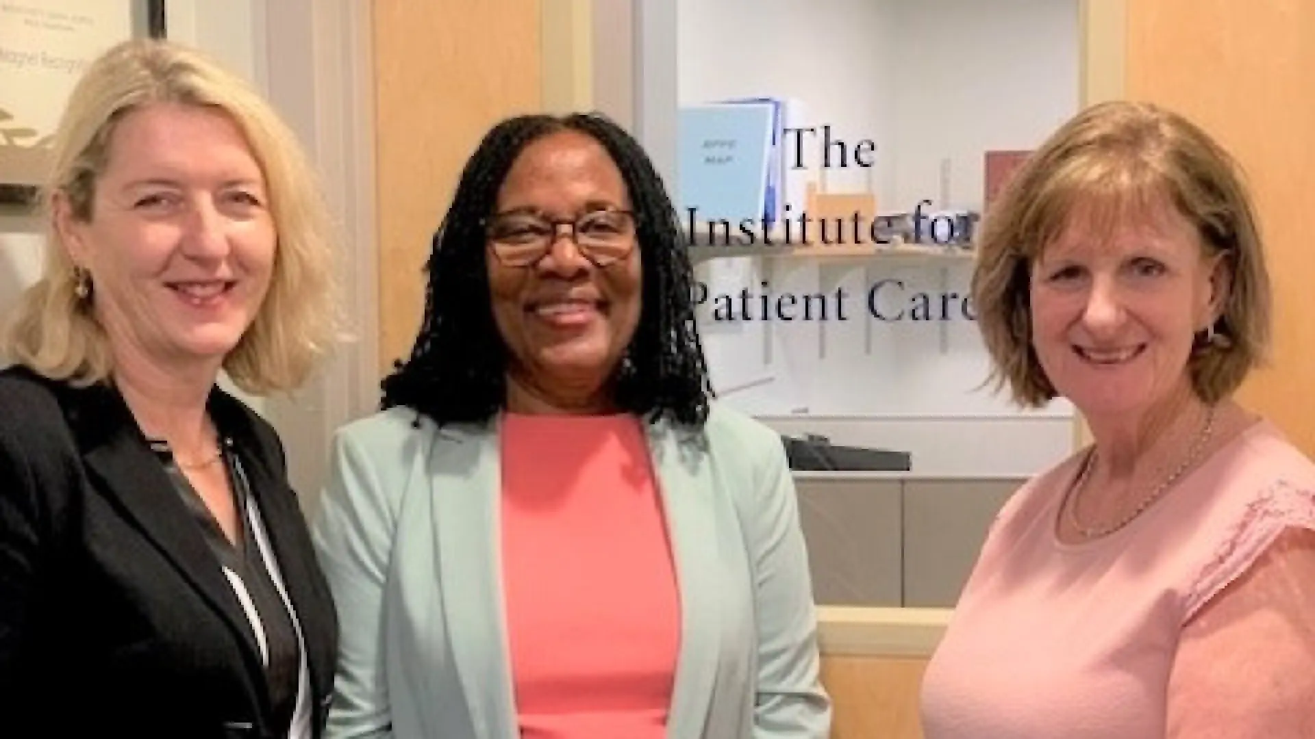 Three woman stand together smiling