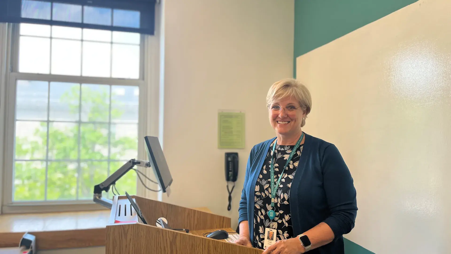 Professor Andrea Pittman stands in front of podium in classroom