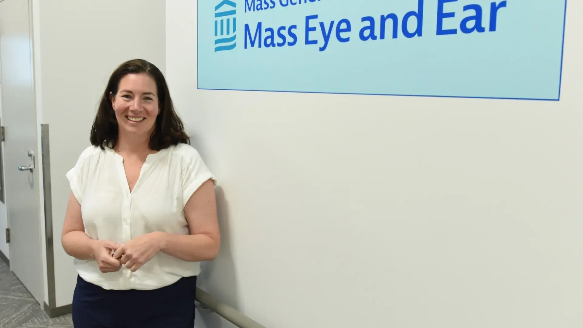Woman standing in front of sign