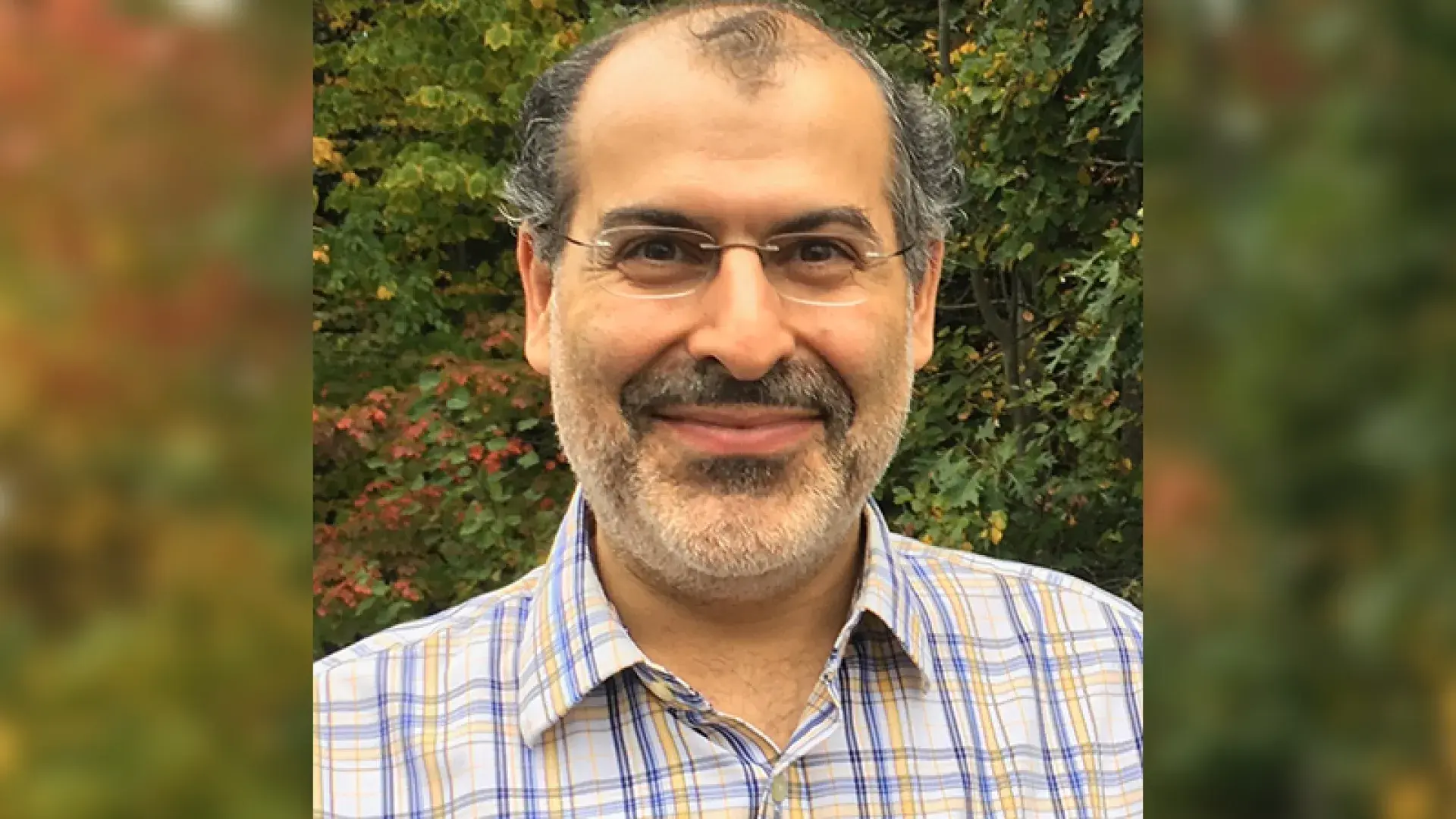 photo of pedram in front of fall foliage
