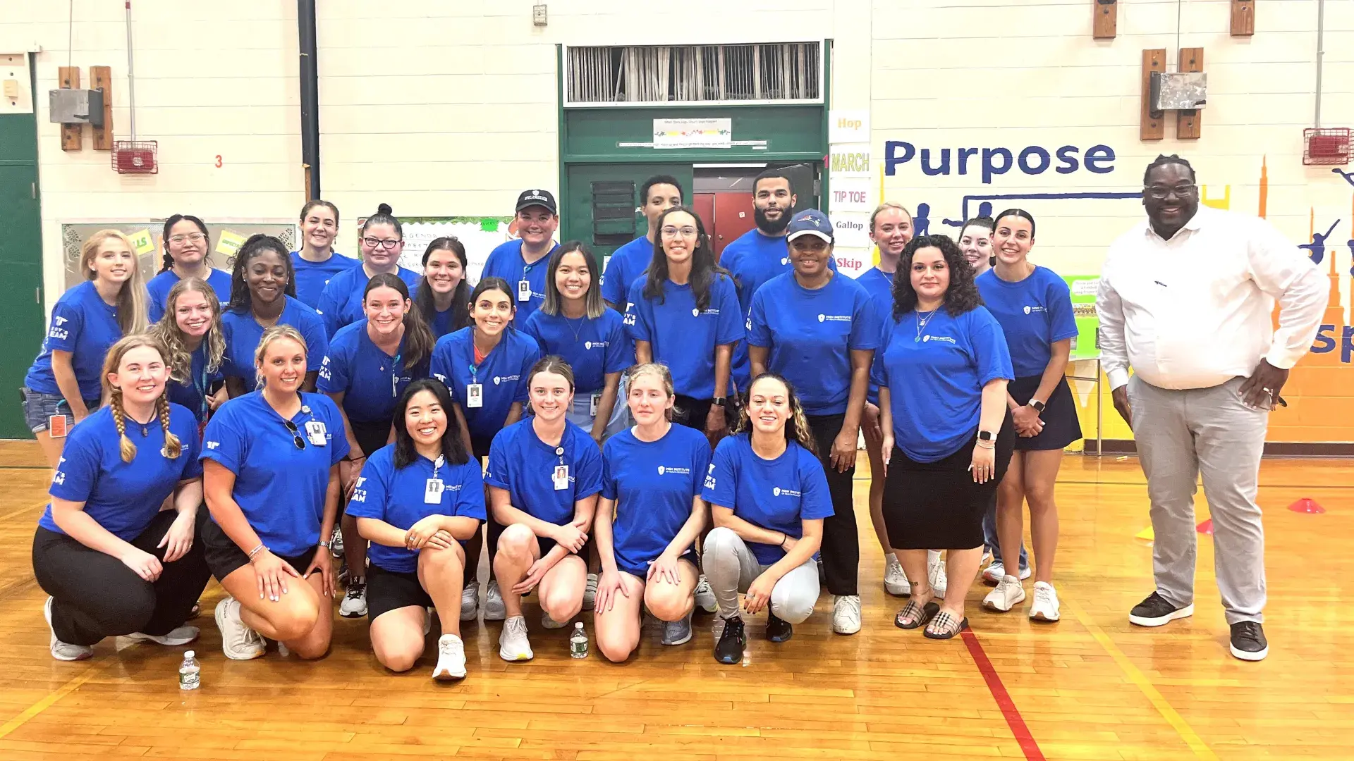 Group of people in a school gymnasium