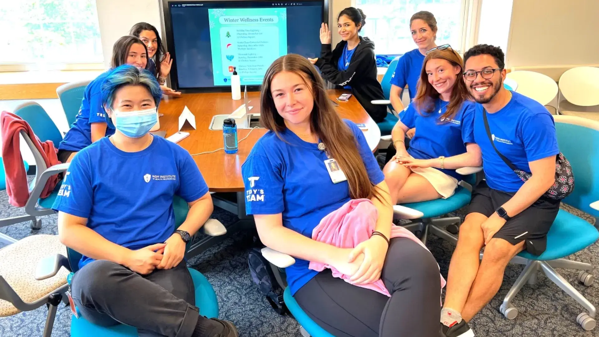 8 students sitting at a table