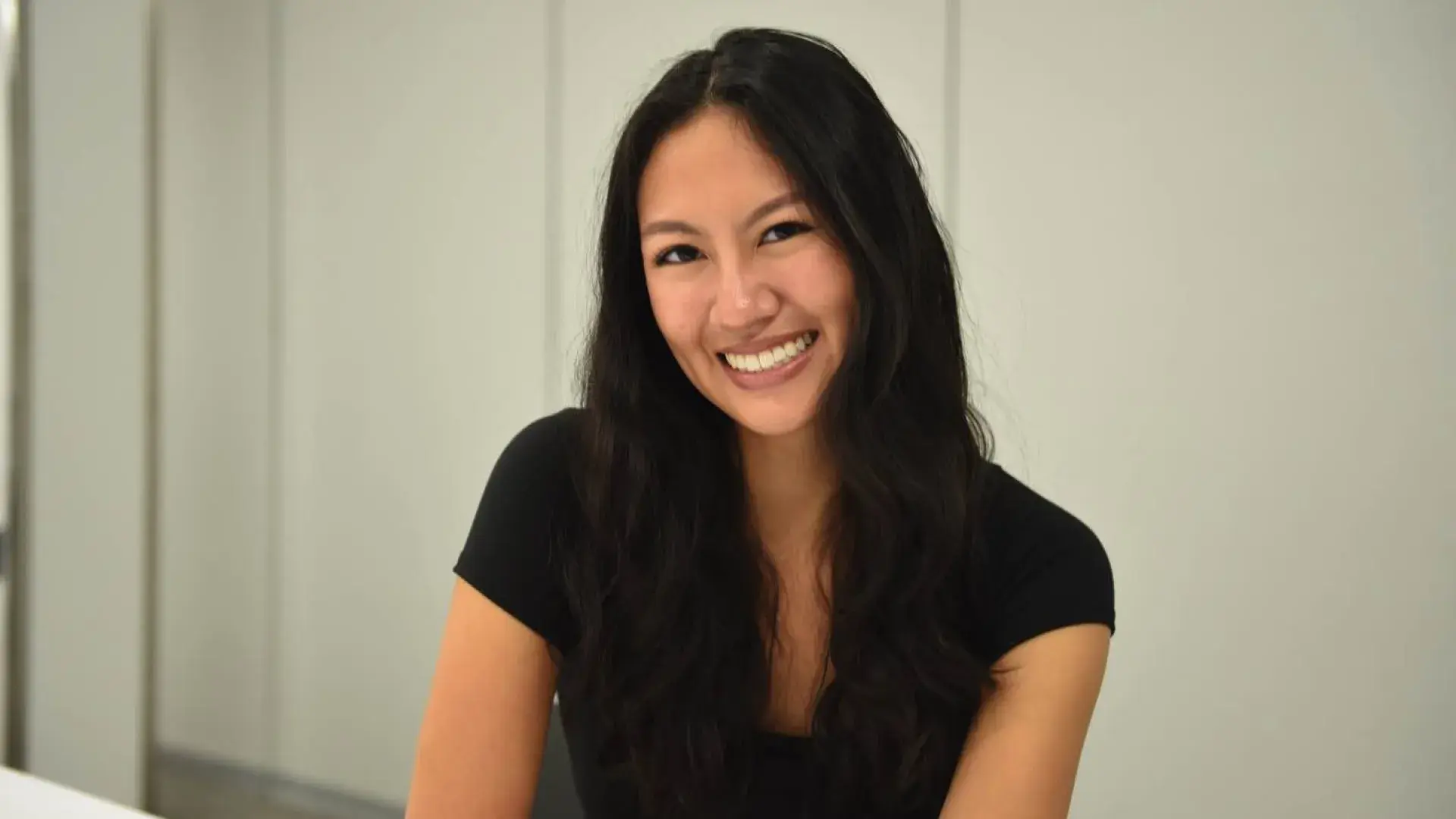 Person in black top smiling
