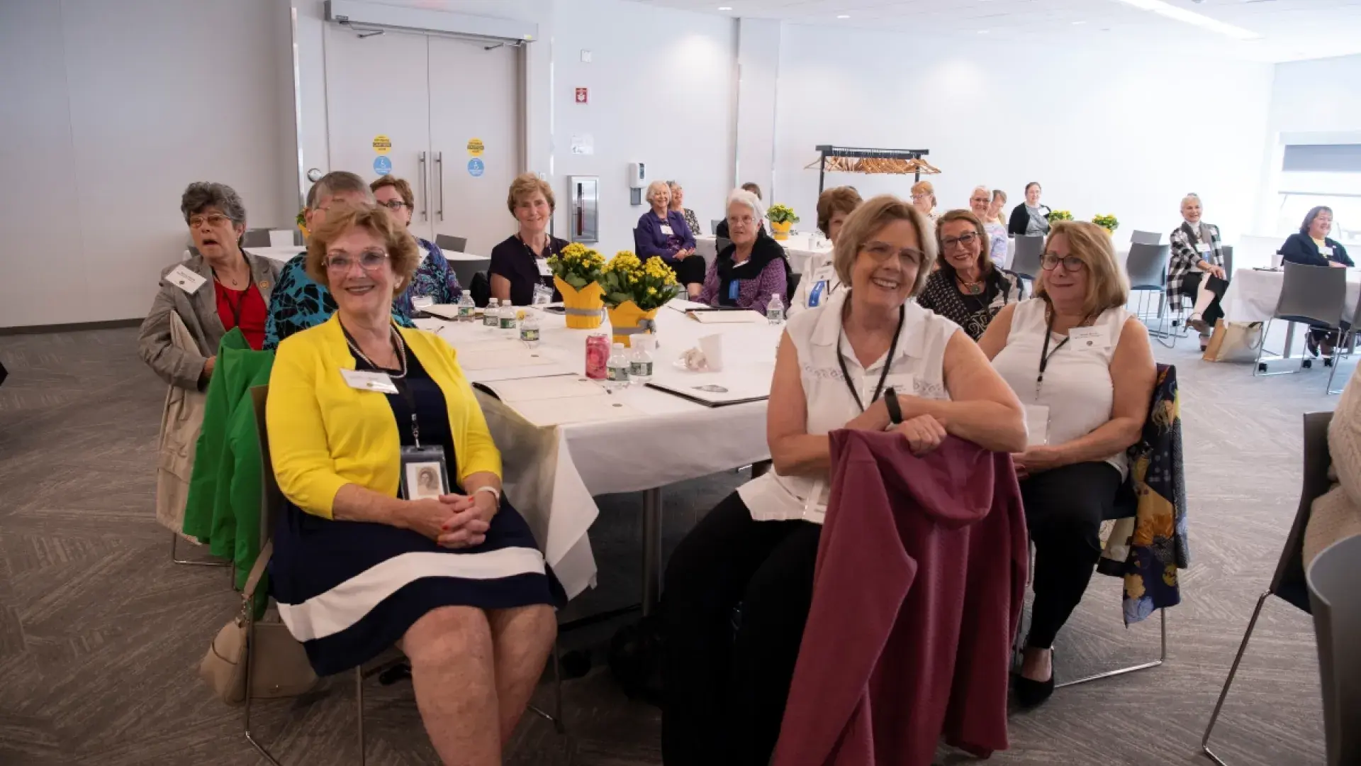 Woman smiling sitting at table in conference room